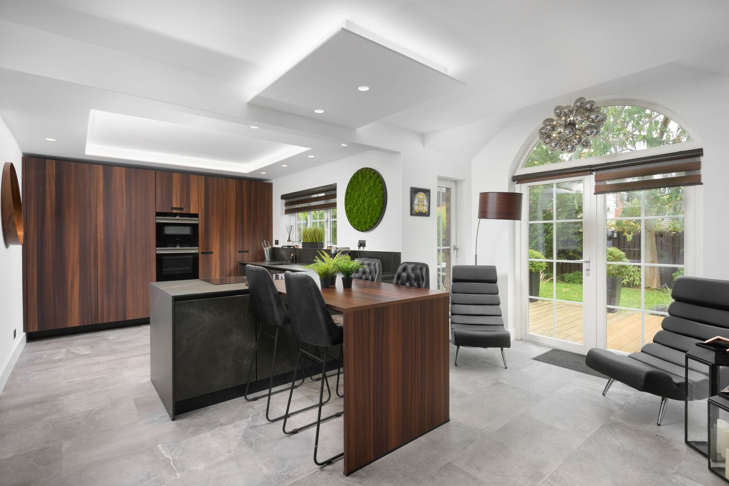 Modern stylidh kitchen with seating area to garden and large breakfast bar