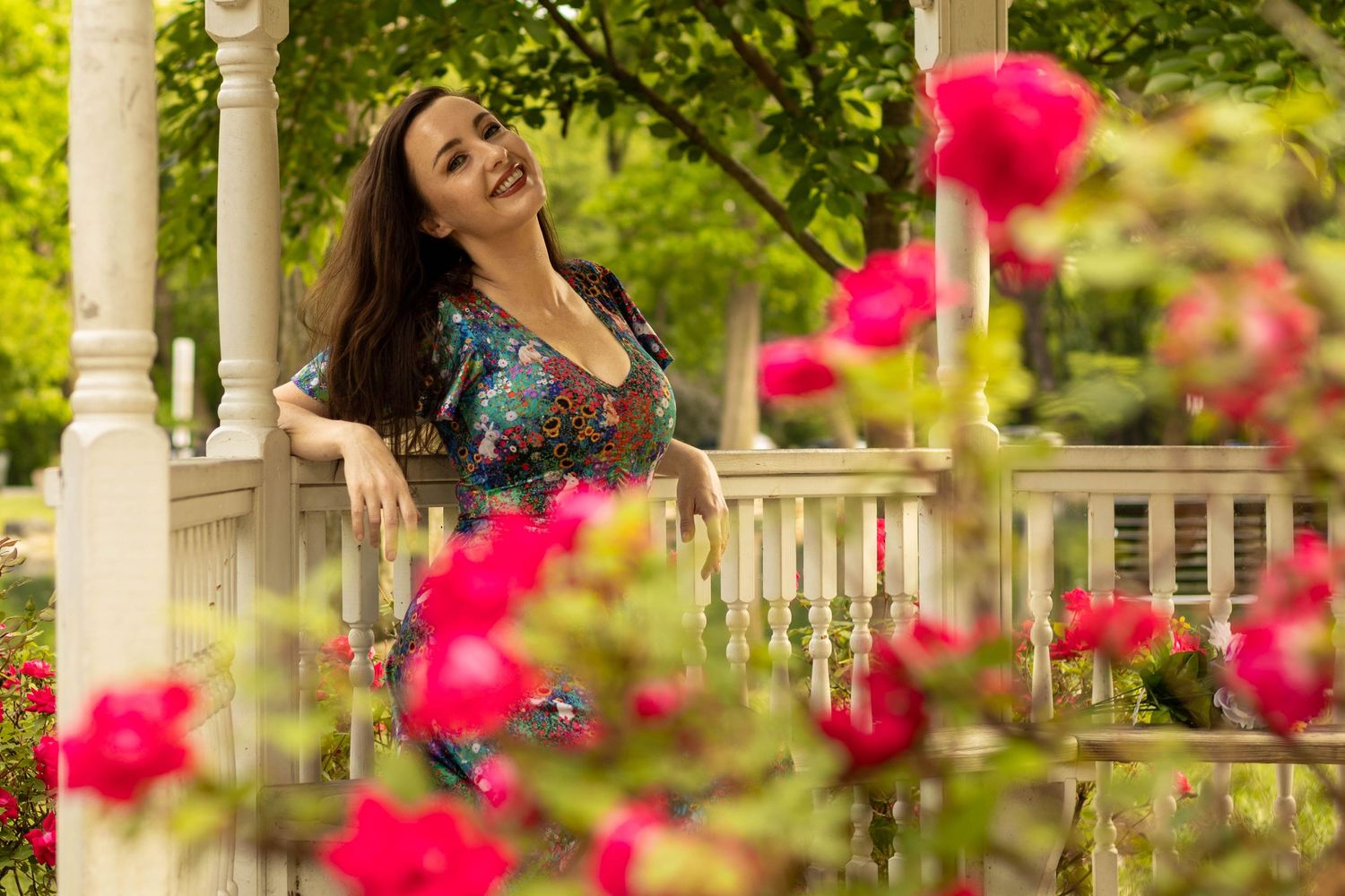 Central PA portrait solo session woman sitting in gazebo with flowers surrounding her at Long's Park by Millie D'Auria Photography
