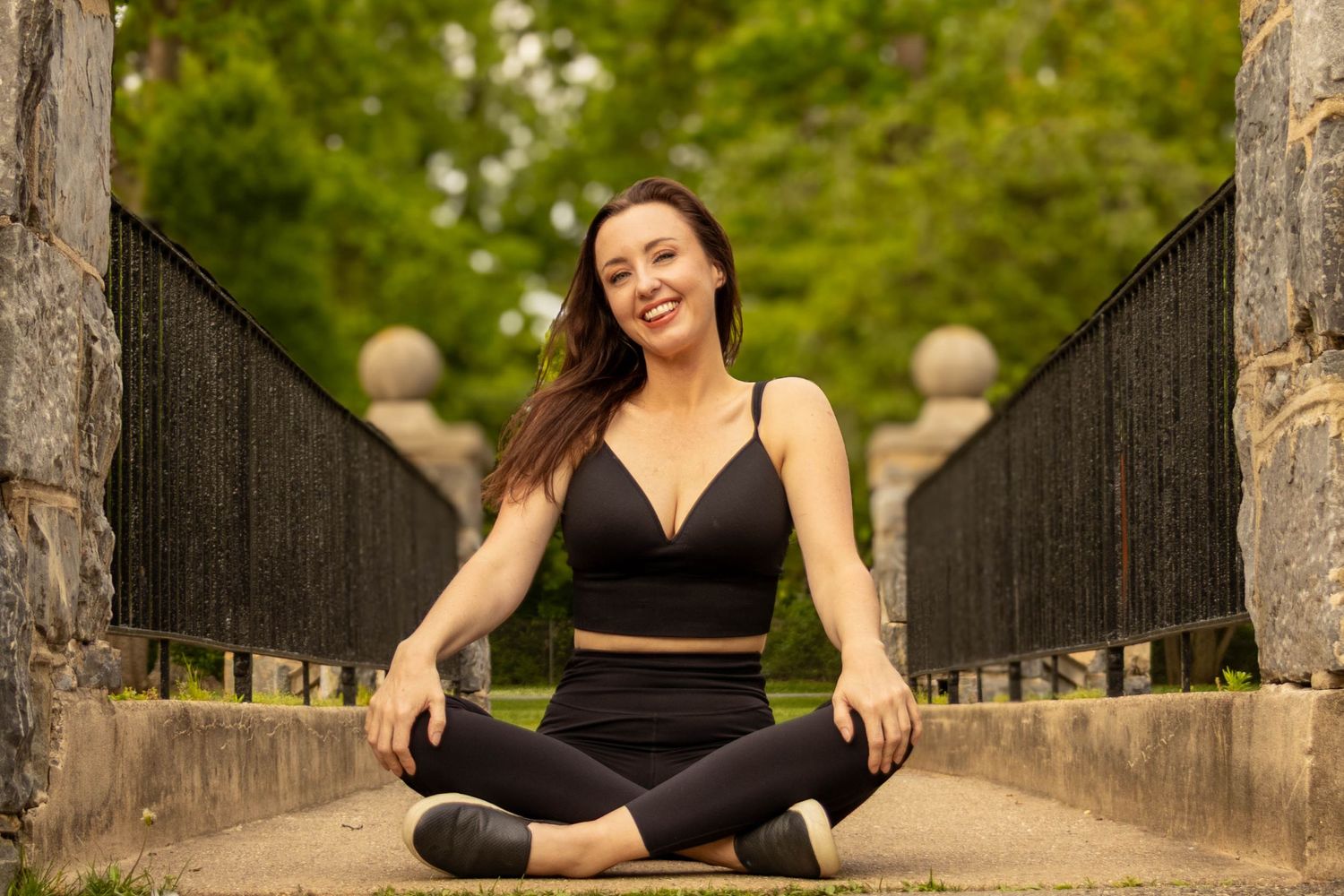 Central PA portrait solo session woman sitting criss cross on bridge at Long's Park in Lancaster, PA by Millie D'Auria Photography