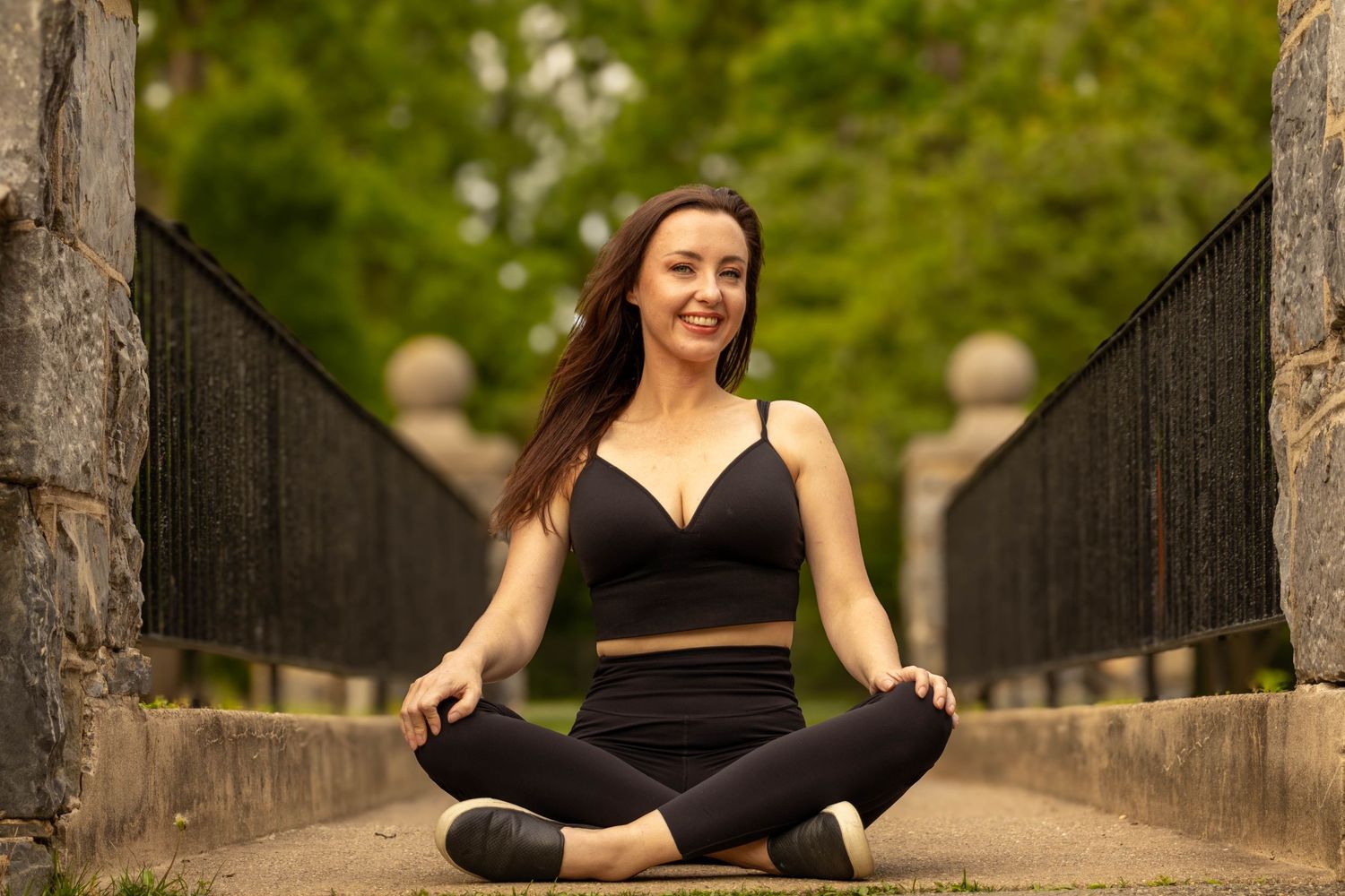 Central PA portrait solo session woman sitting on bridge criss cross at Long's Park in Lancaster, PA by Millie D'Auria Photography