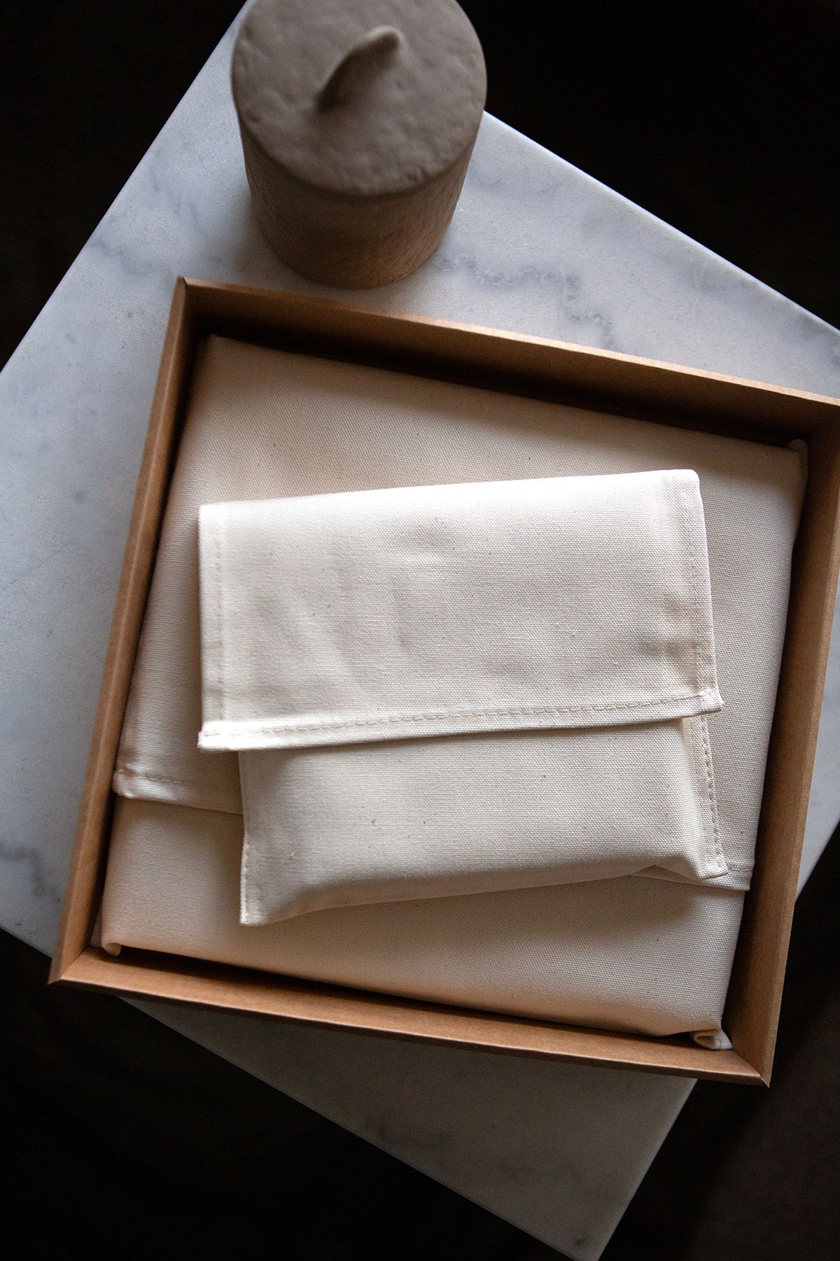 Two wedding albums contained in fabric pouches by Luxe Albums.