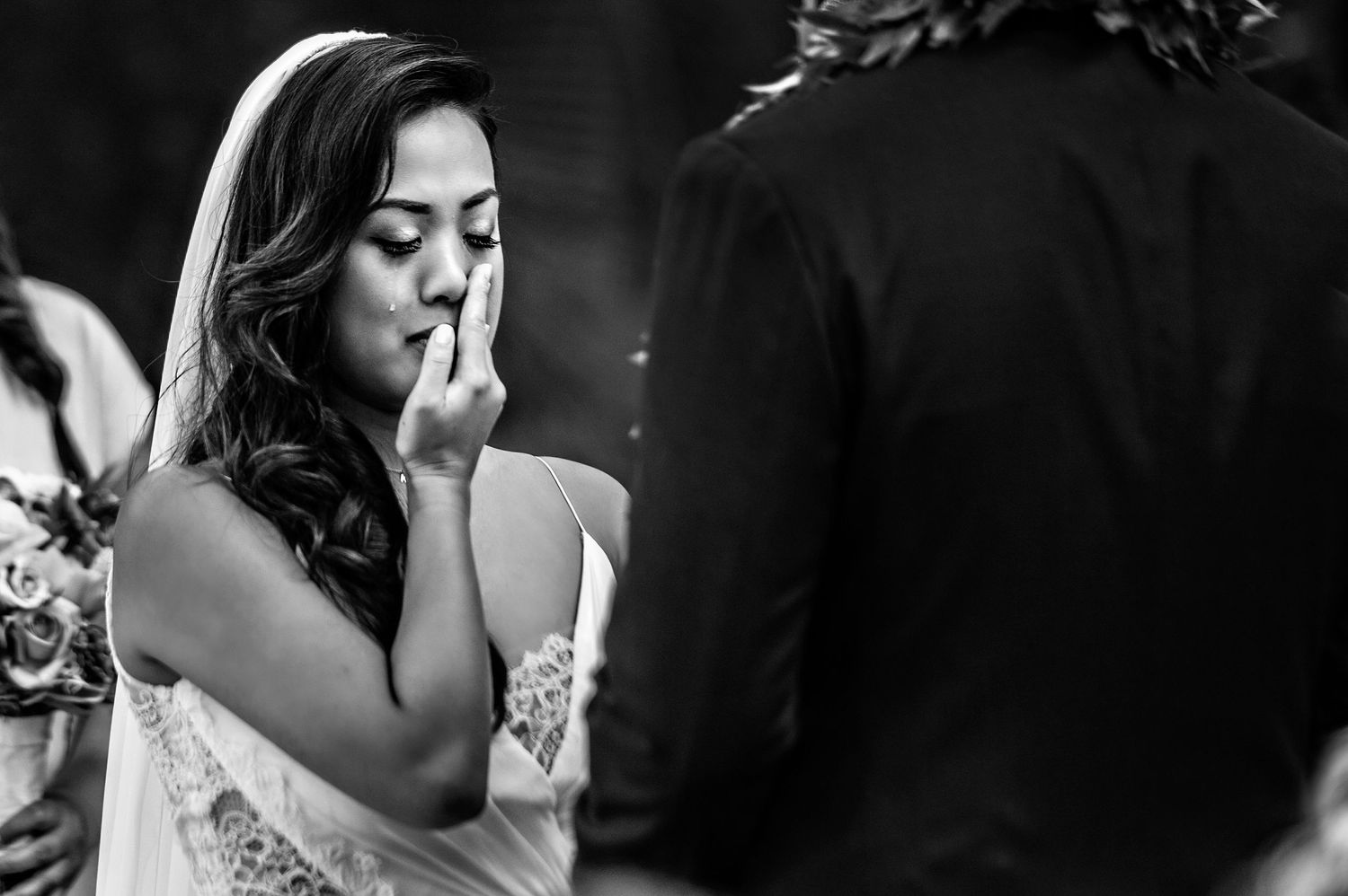 Black and white montage capturing candid emotional moments between people during a wedding celebration.