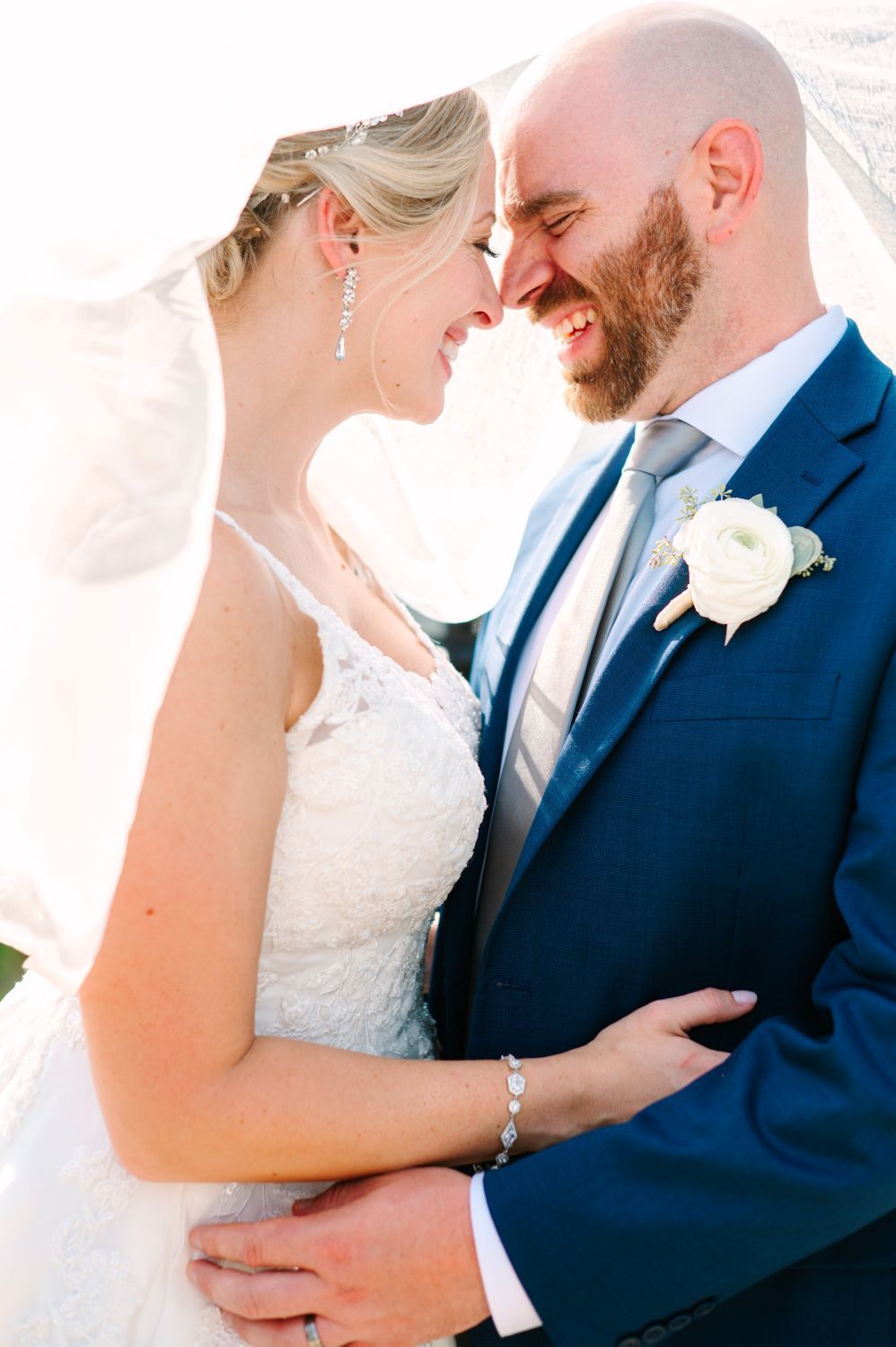 Romantic wedding couple in navy suit and white dress share intimate moments in a series of close-up photos.