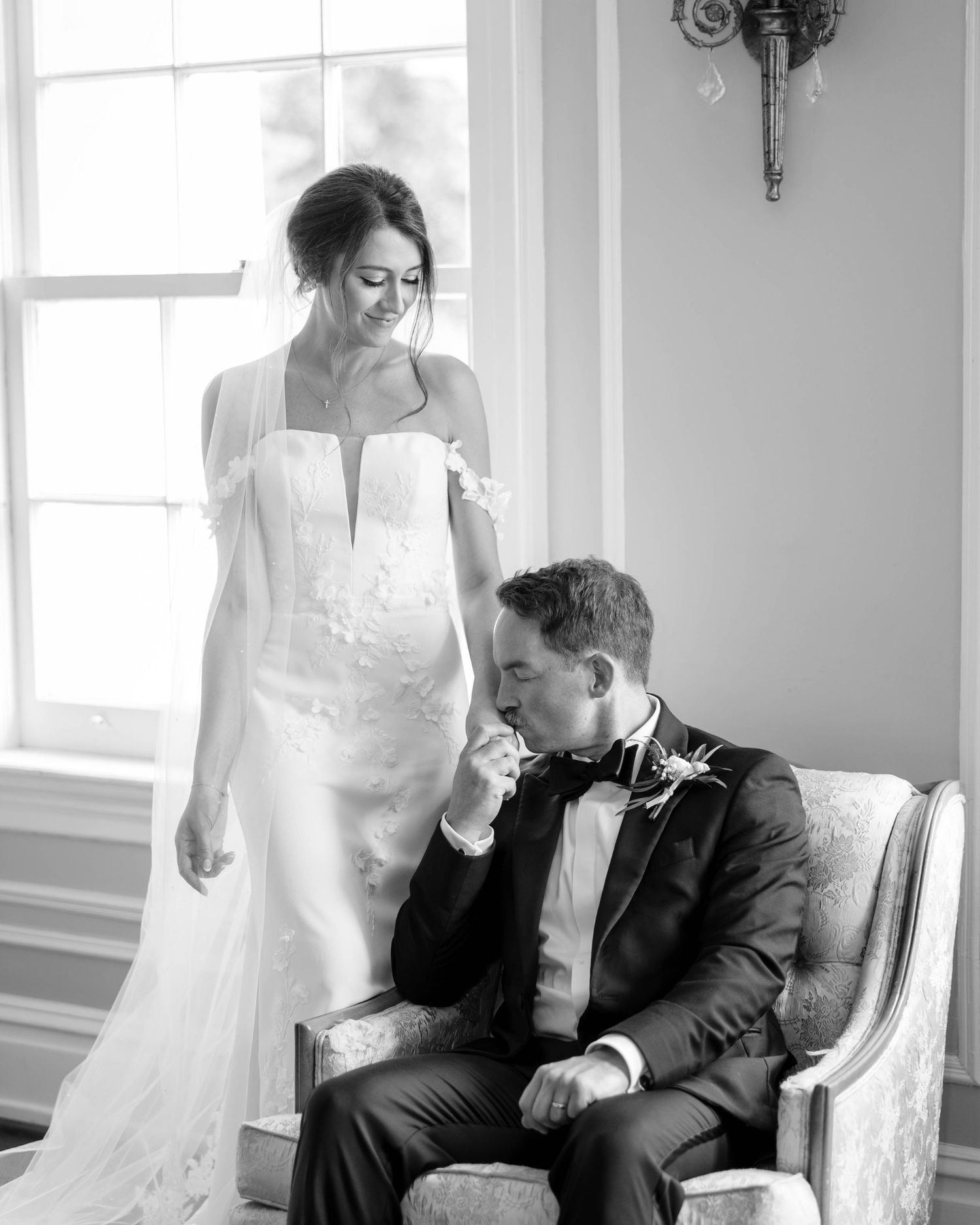 A candid black and white wedding photo series showing tender moments between a couple in formal attire.