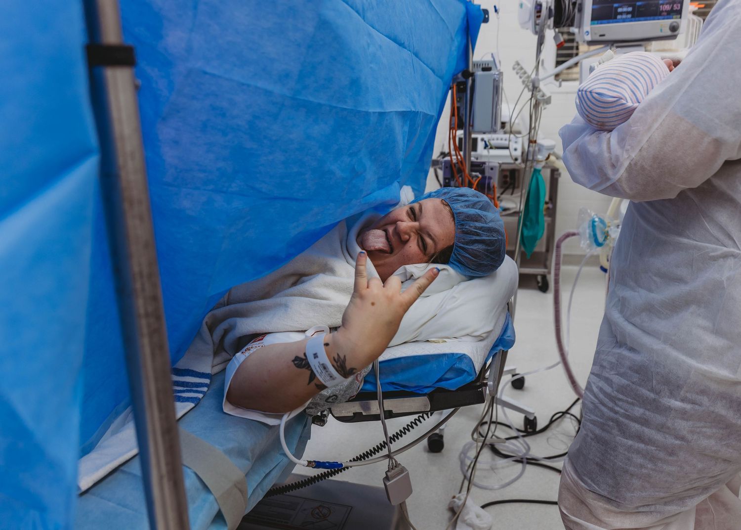 Patient lying on medical gurney in surgical cap with healthcare worker nearby in clinical setting.
