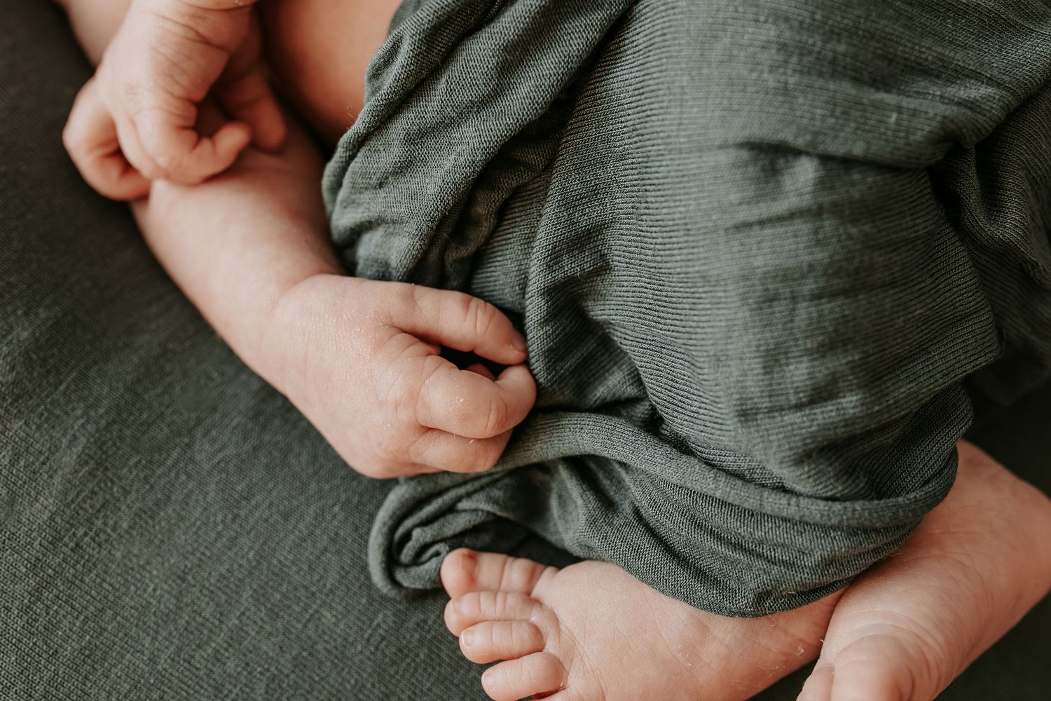 Detail shot of a newborn's hands and feet while wrapped. Taken by Keely King Photography in Coweta Oklahoma.