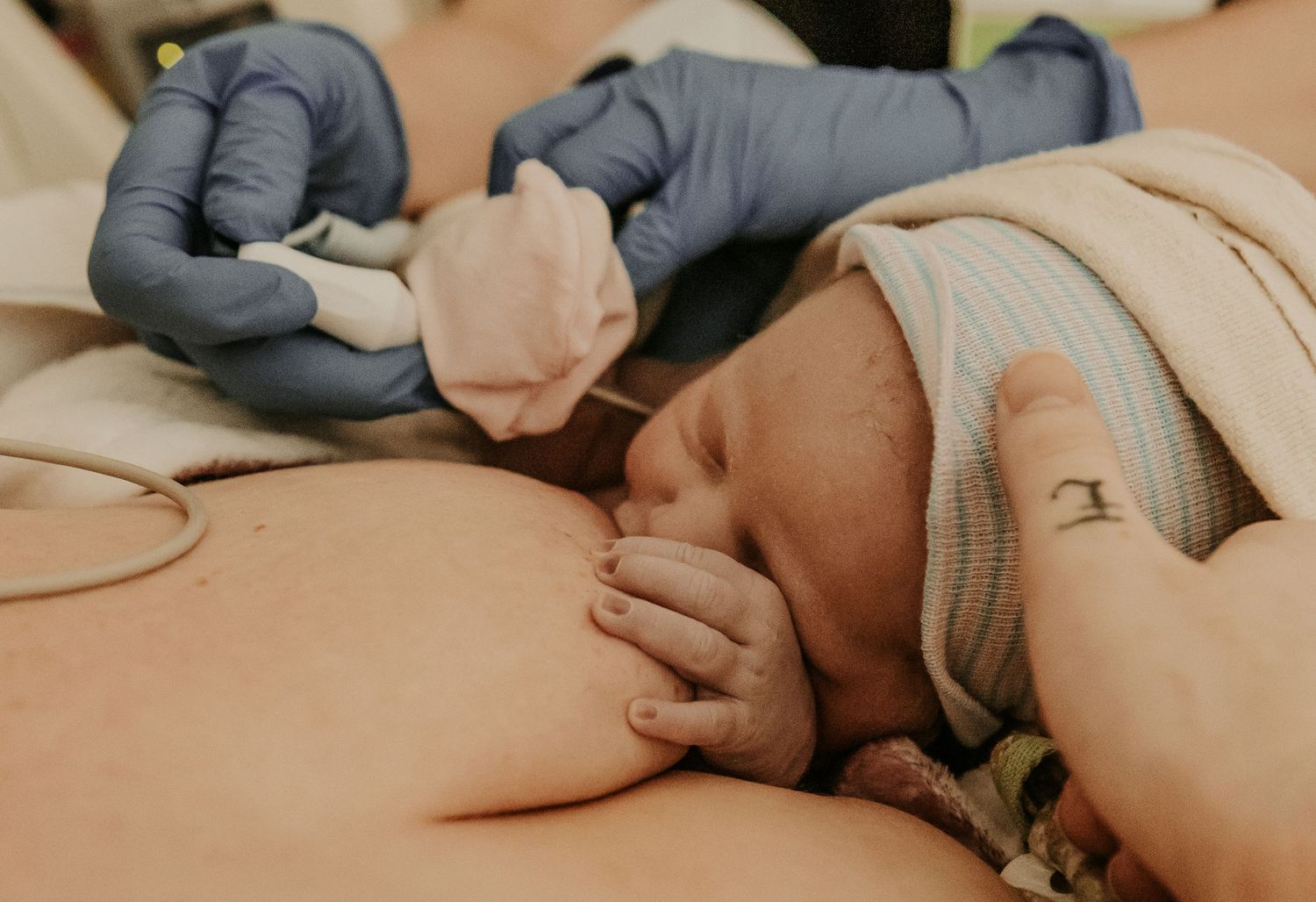 Keely King Photography captures baby's first nursing latch while in the hospital recovery room after a scheduled c section in Tulsa Oklahoma