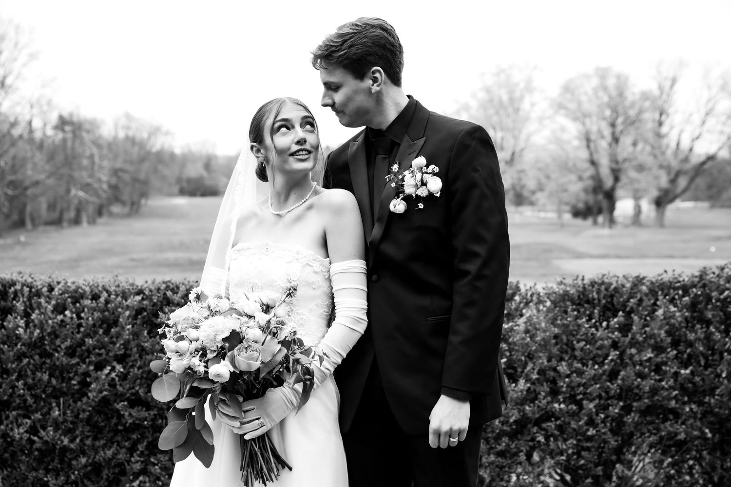 Bride and groom sharing a moment outdoors at Flourtown Country Club in Pennsylvania after their wedding ceremony.