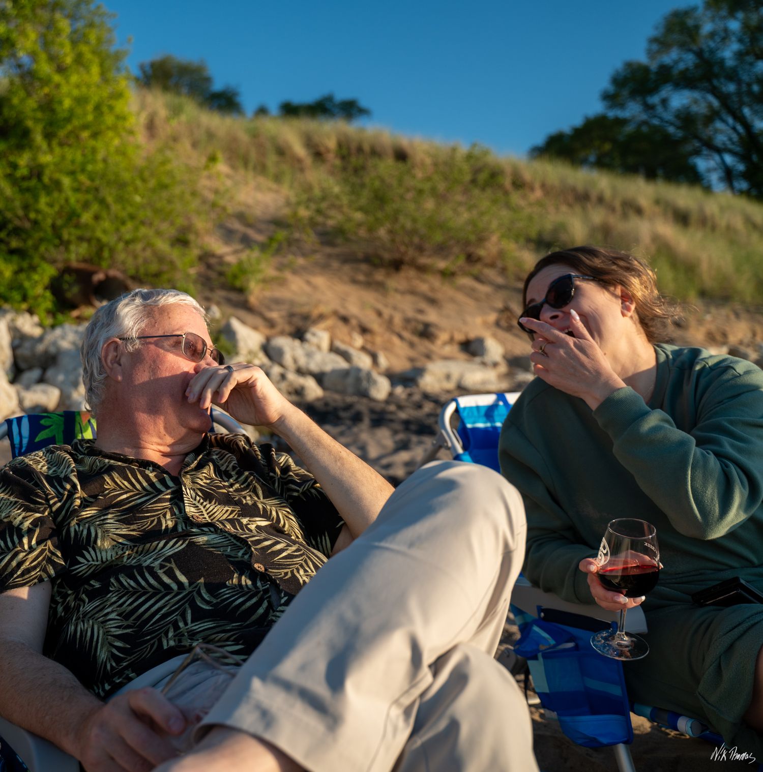 two people having a conversation at the beach