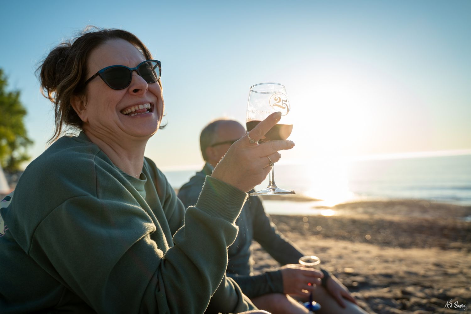 Lady smiling with sunset in the rear
