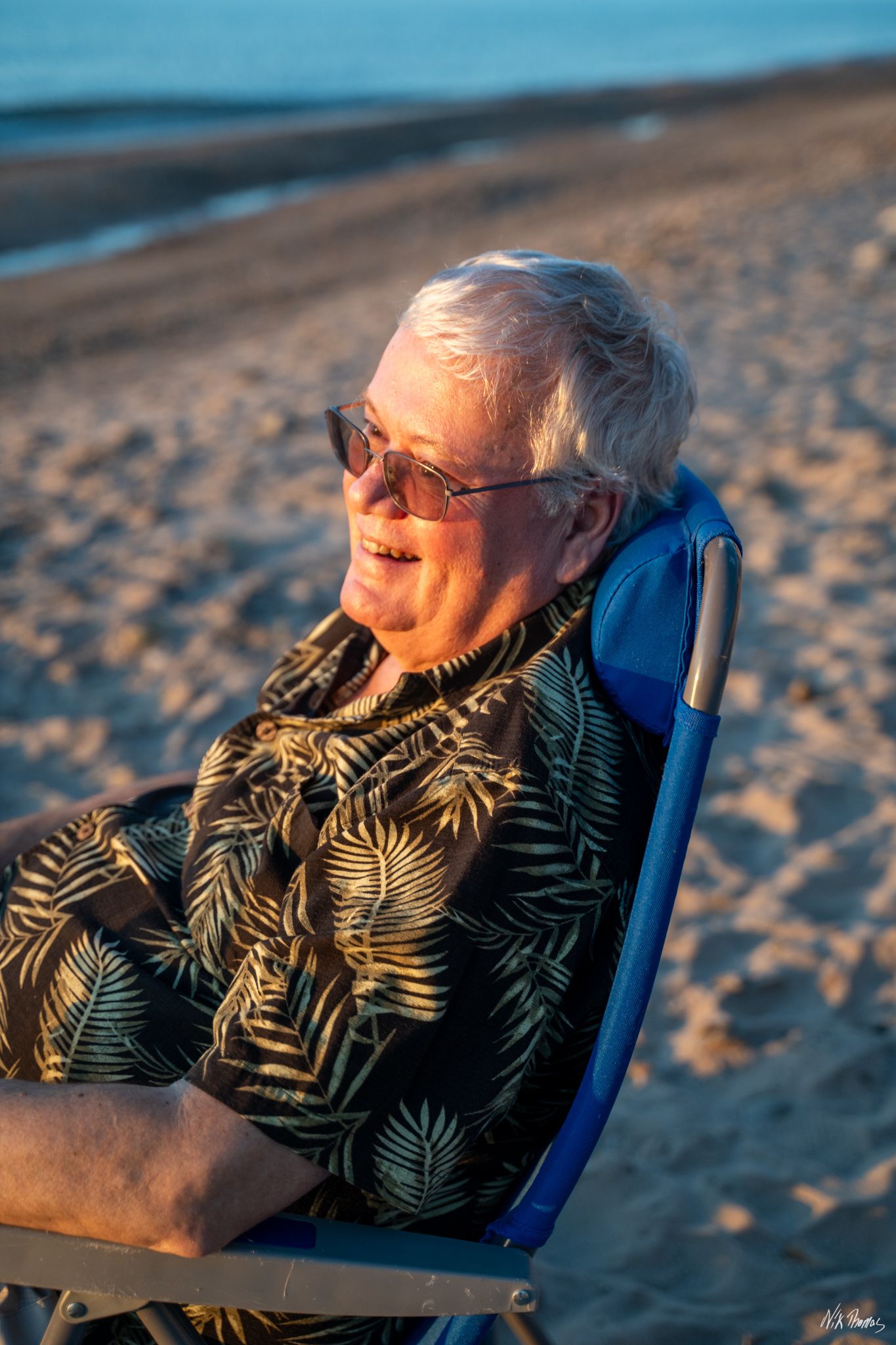 Man sitting in chair at the beach