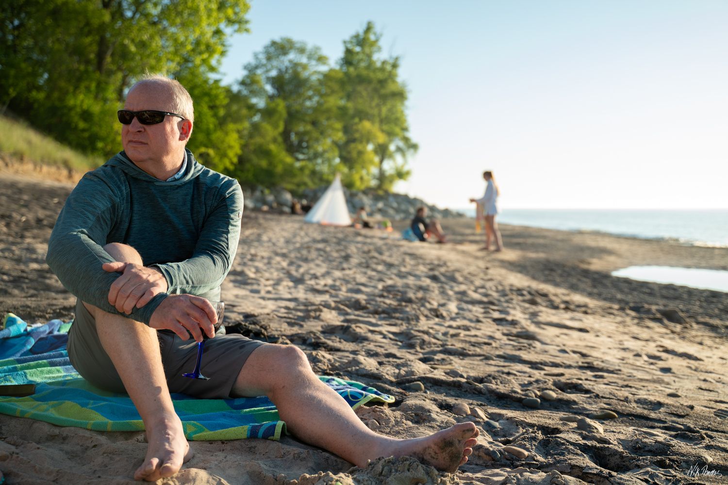 man sitting on the sand at the beach