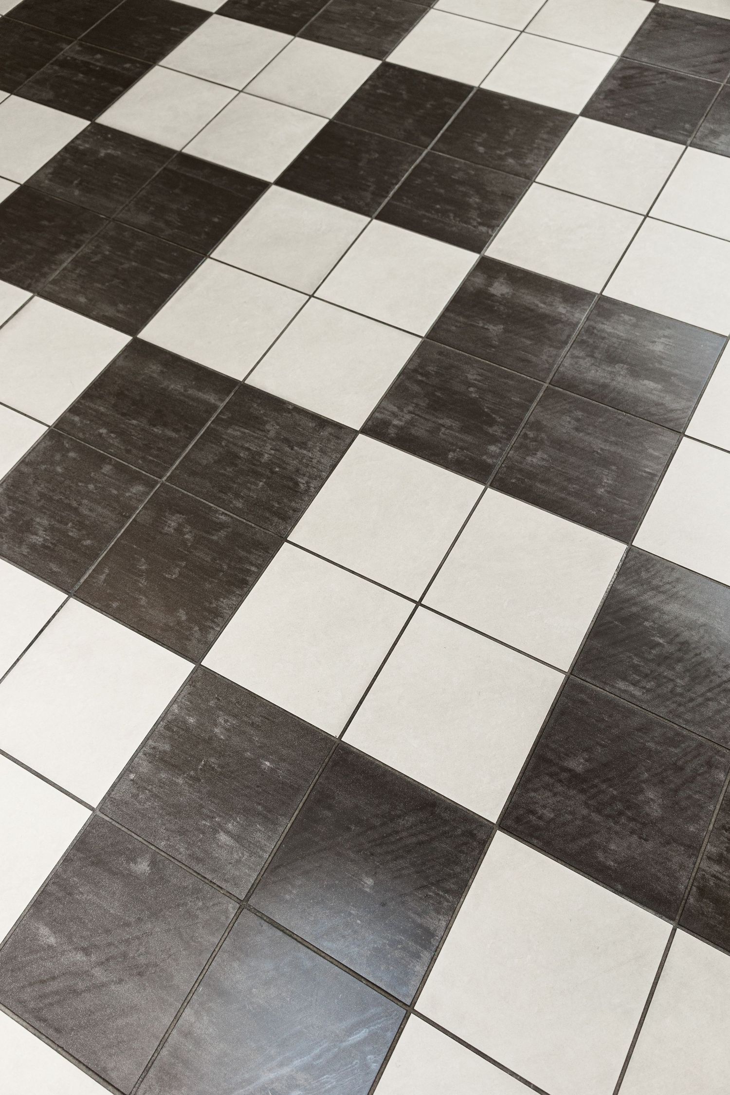 Black and white checkered tile floor pattern in a classic alternating square design.