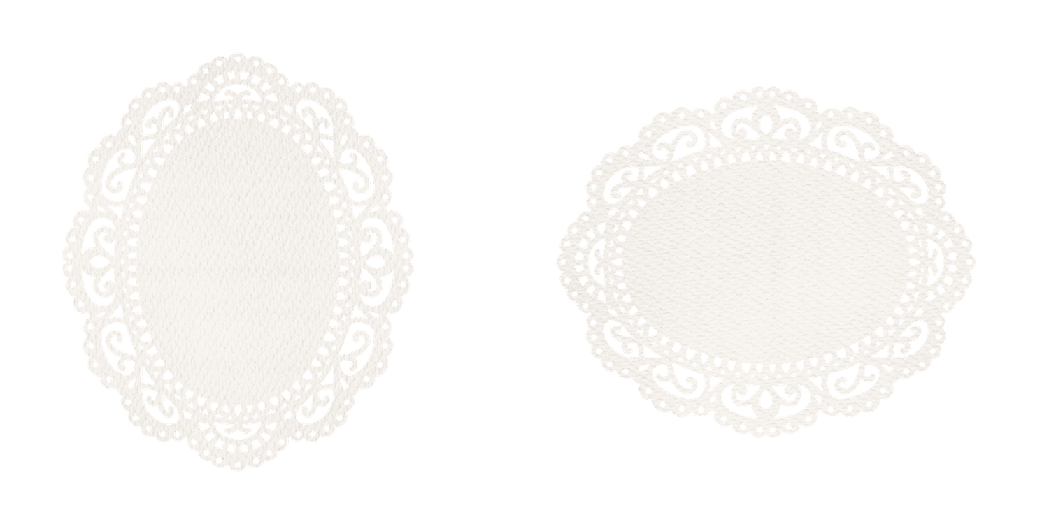 Two white oval decorative lace doilies on a plain white background.