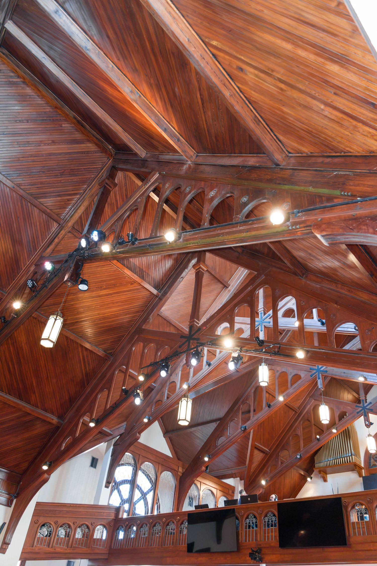 Stunning wooden cathedral ceiling with arched beams and elegant pendant lighting.