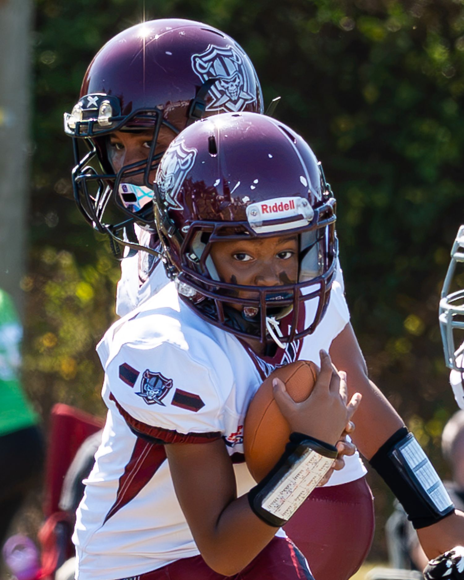 abington raiders football player with football tucked in right hand running to make a touchdown