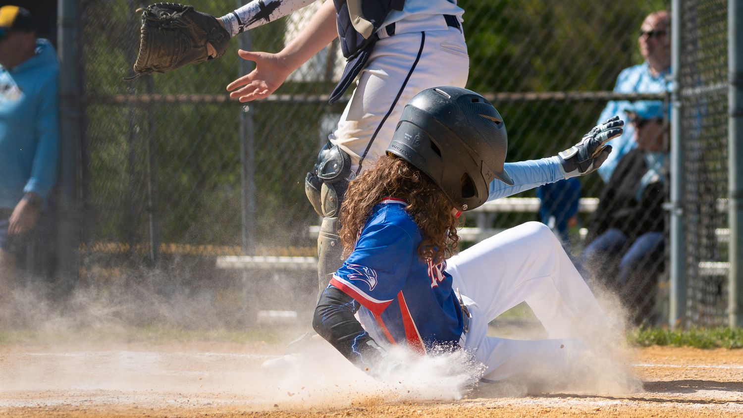 roslyn bluehawks baseball player sliding to home plate
