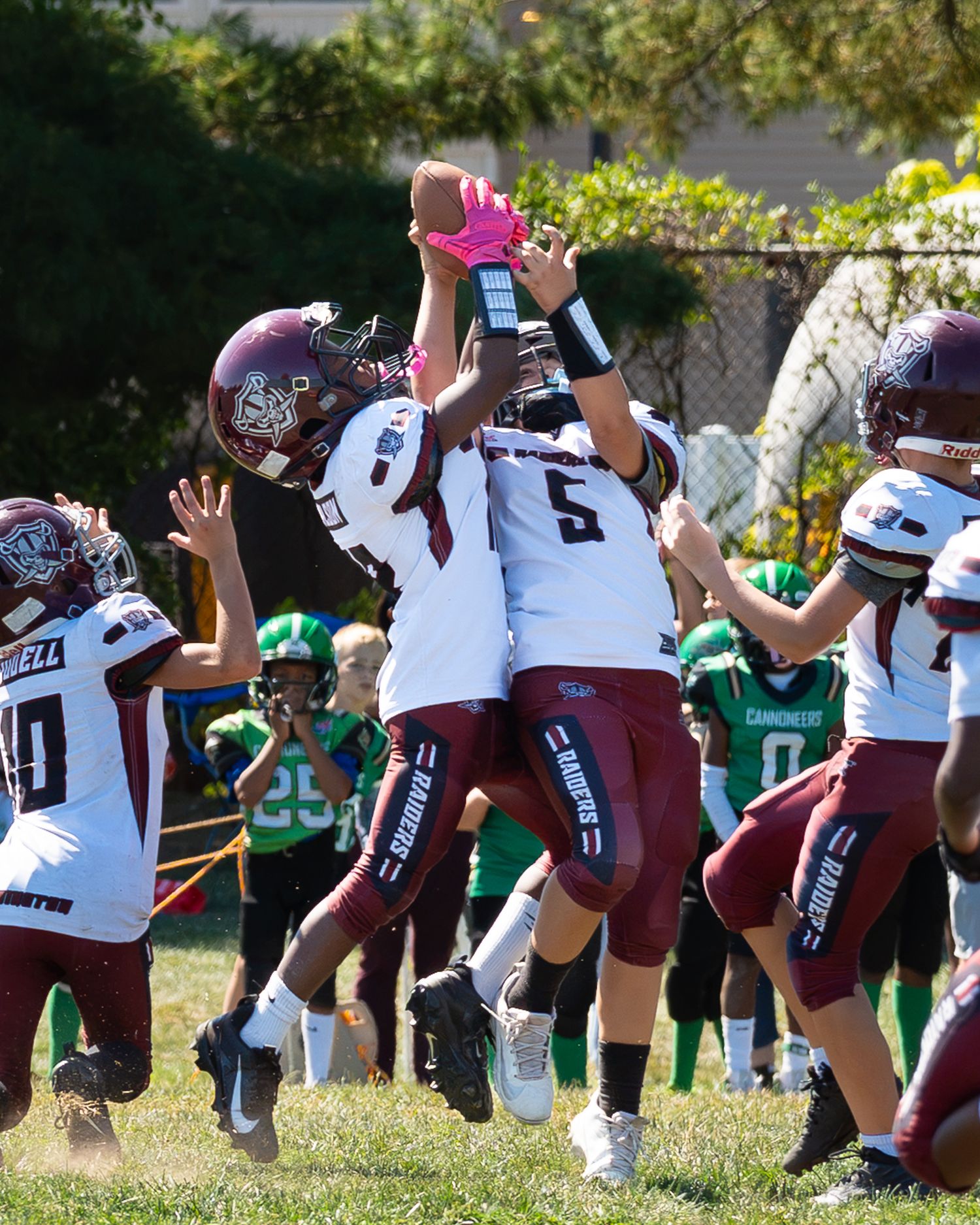two abington raiders football player catching the football in the air