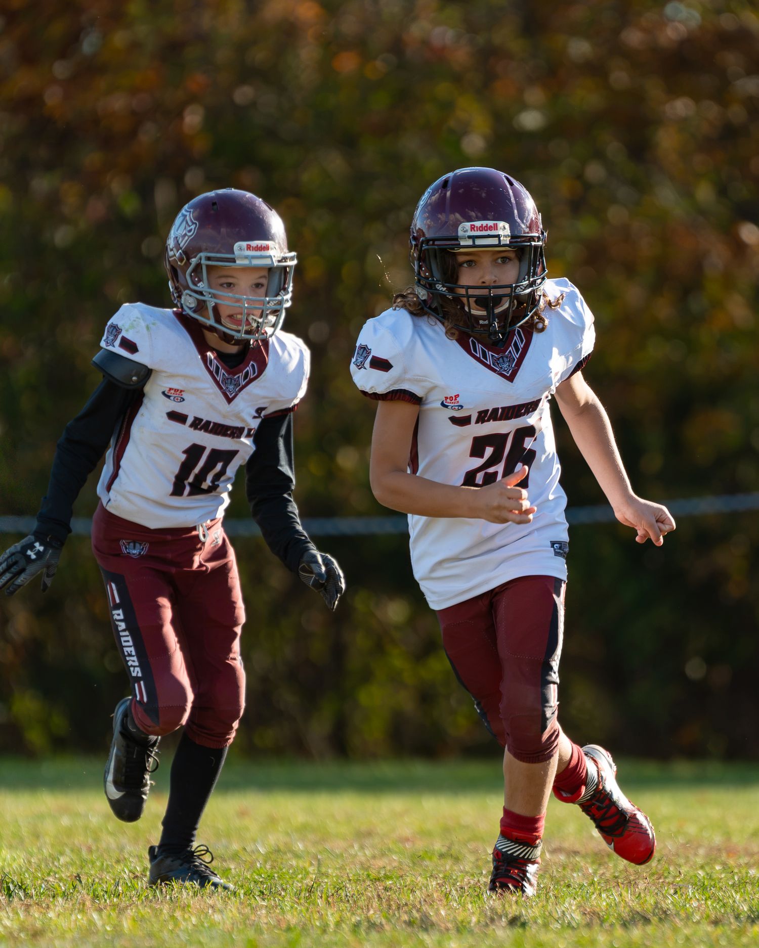 two abington raiders football players out on the field