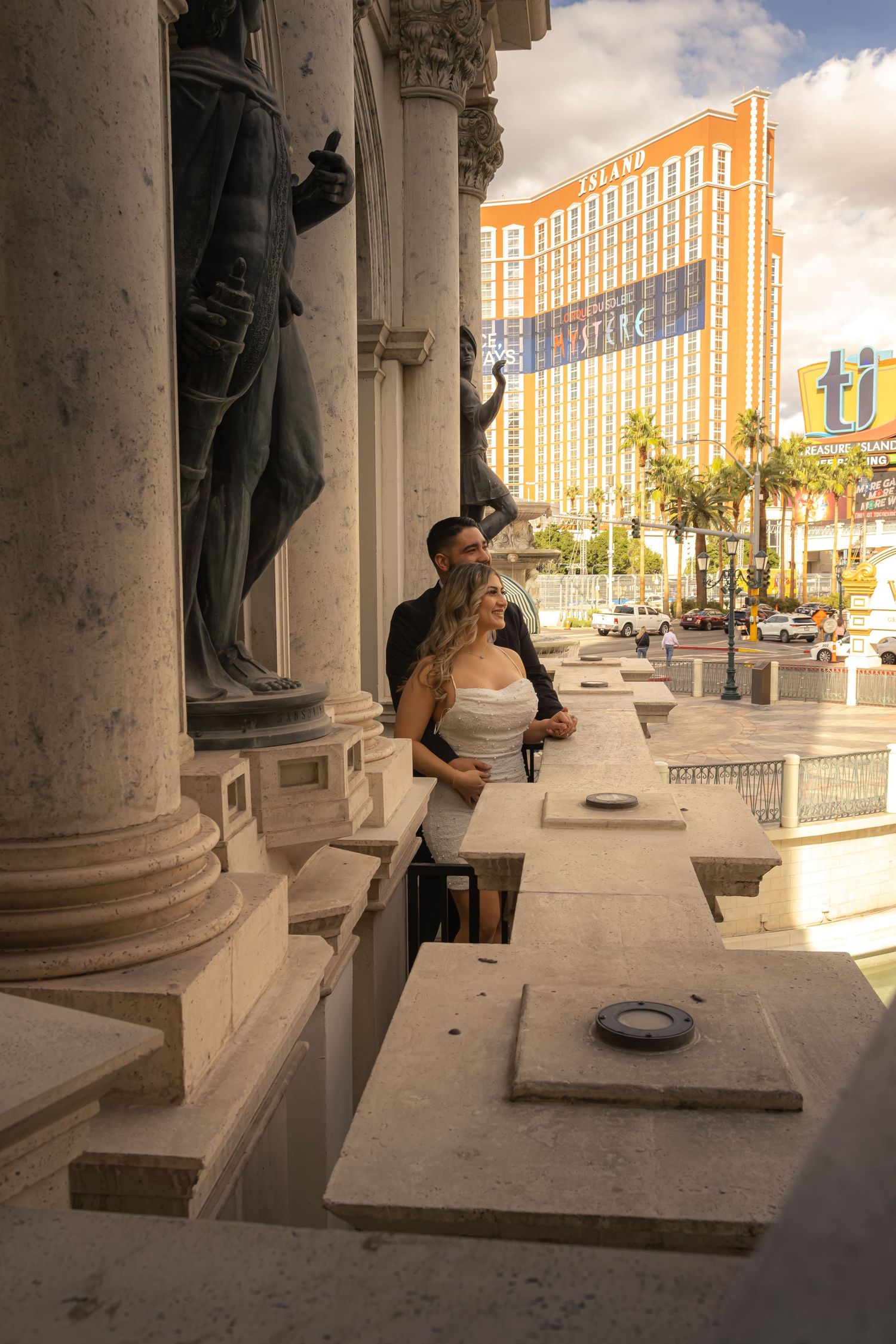 Couple embracing among classical statues and columns at The Venetian Las Vegas Strip.