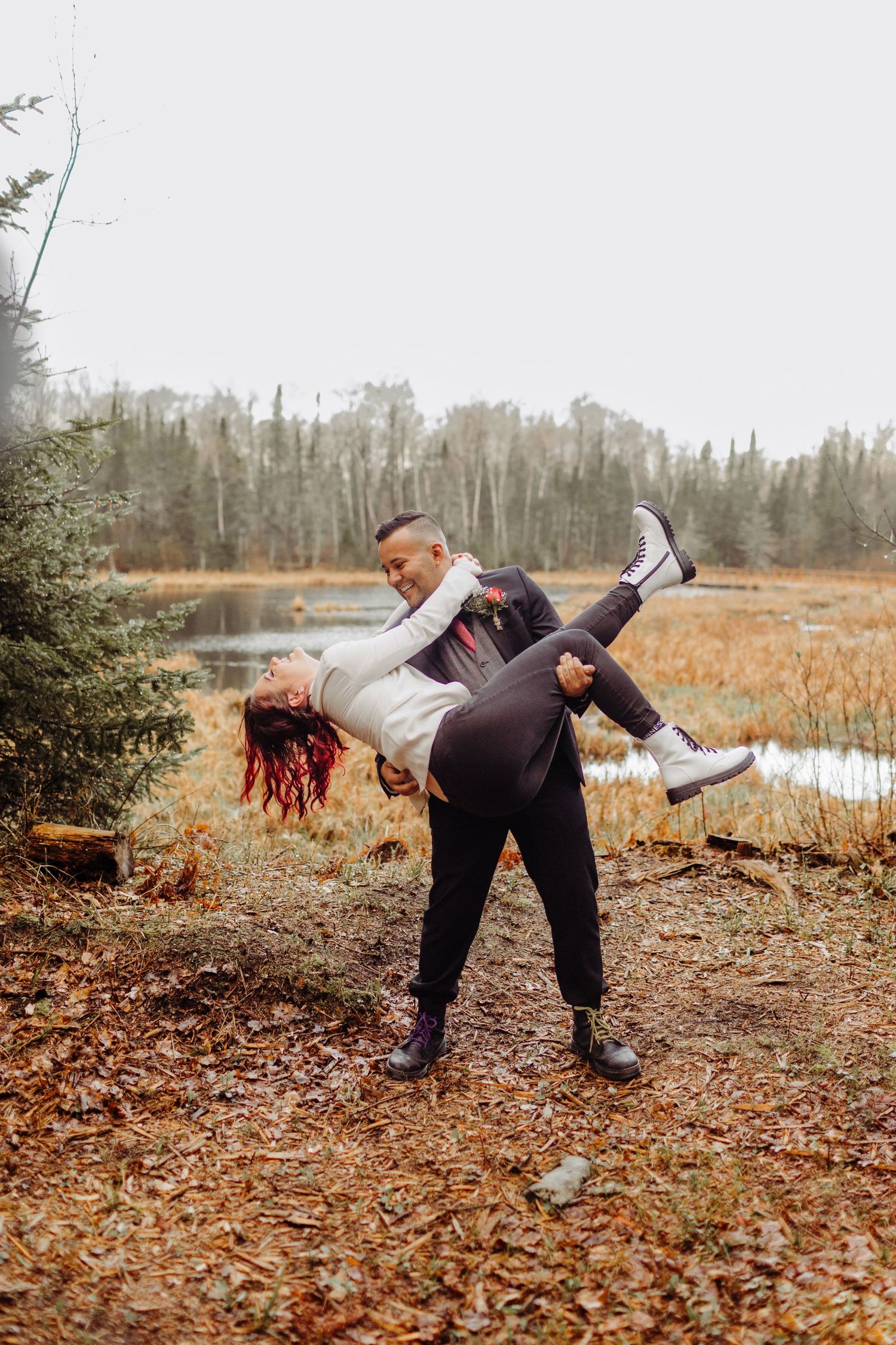 Bride and groom couple, groom is holding the bride and dipping her back.