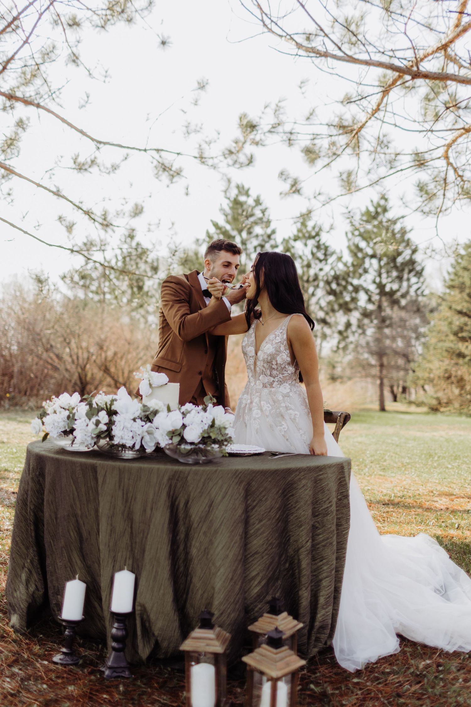 a bride and groom feeding each other cake after celebrating and intimate wedding.