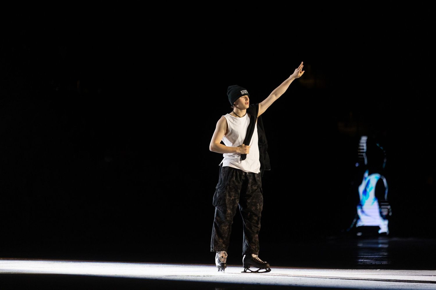 Ilia Malinin, figure skater, Ending his program with one arm up in the air with a peace sign to the crowd.