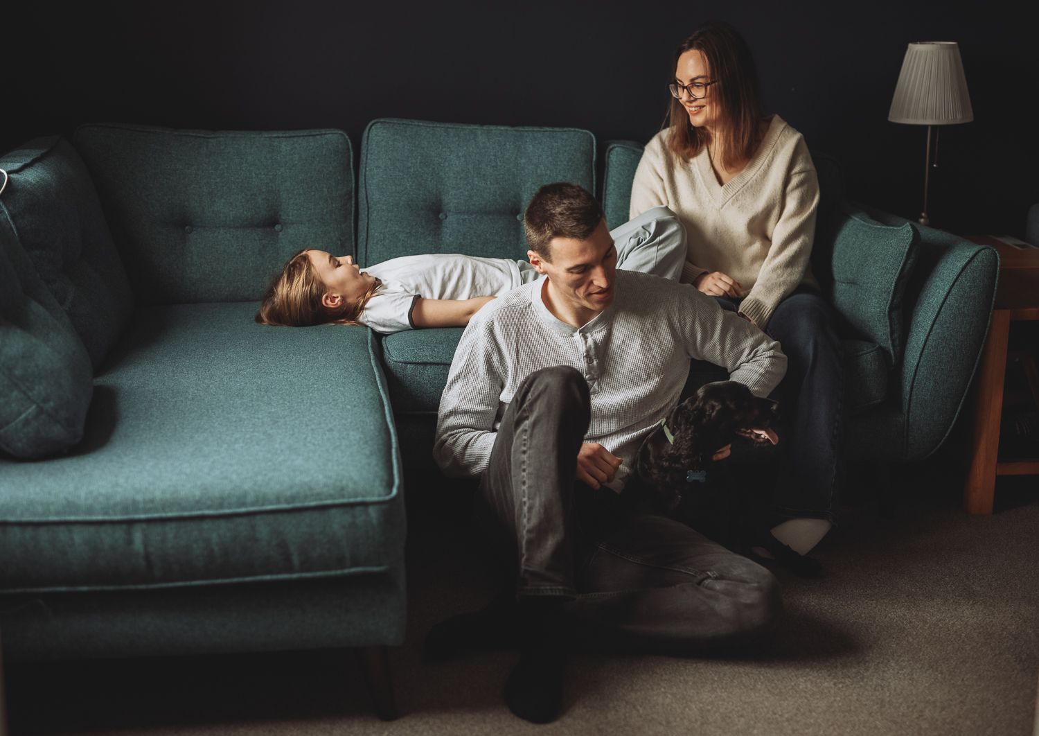 Family sitting together on a sofa  during lifestyle photoshoot in Angus