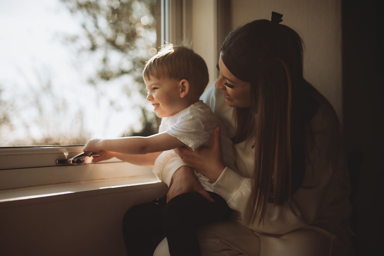 Candid moment between mother and son during home photoshoot