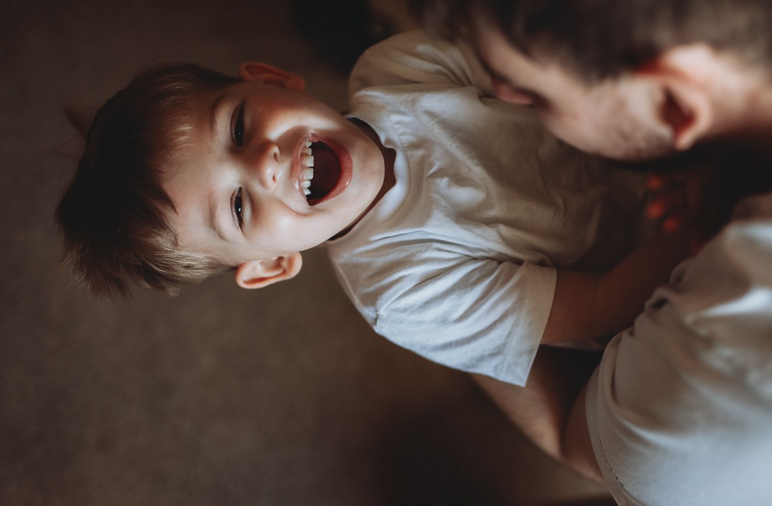 Natural light family photographer in Dundee and Angus capturing real moments during a home photoshoot