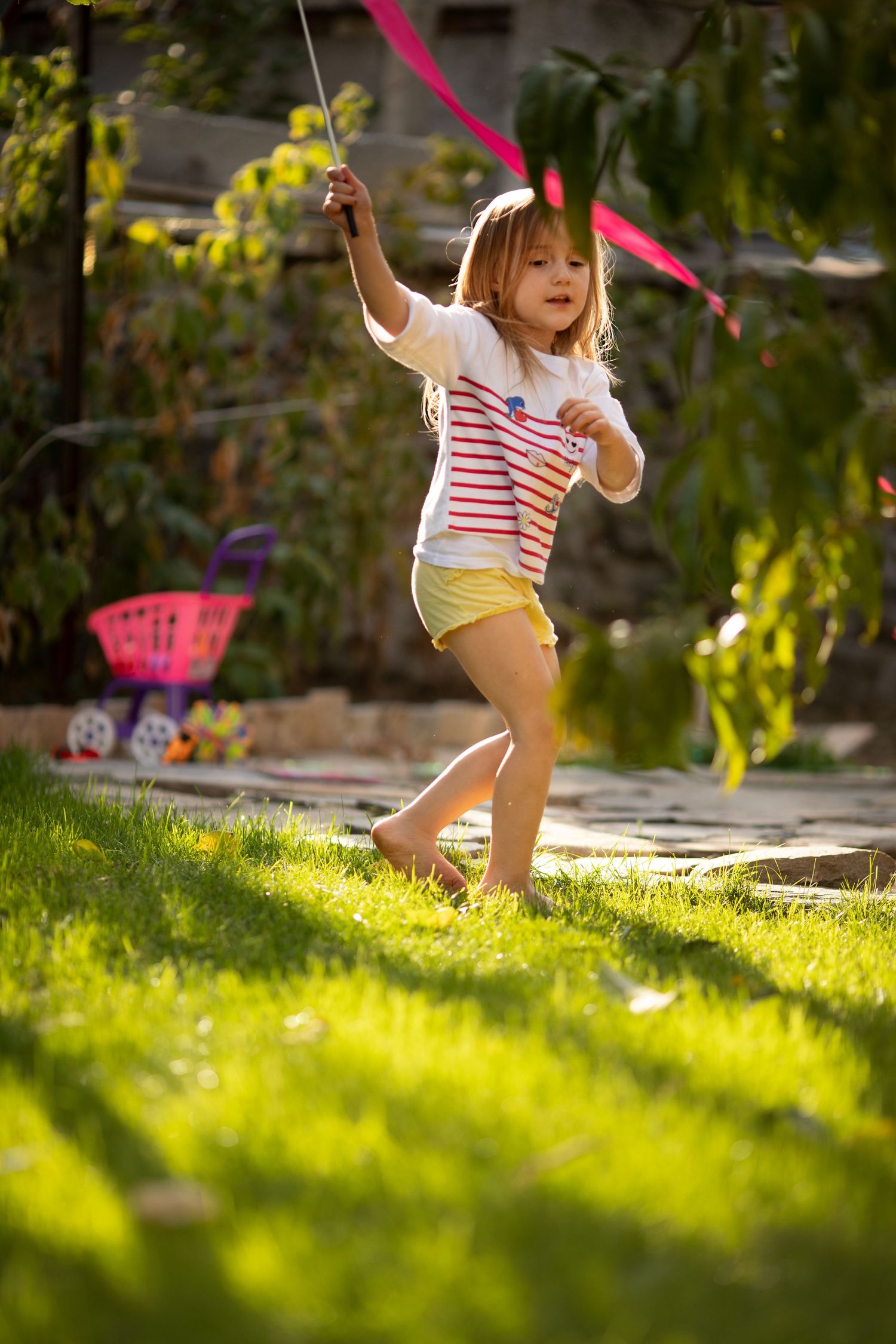 Outdoor family photography with a child playing in the garden