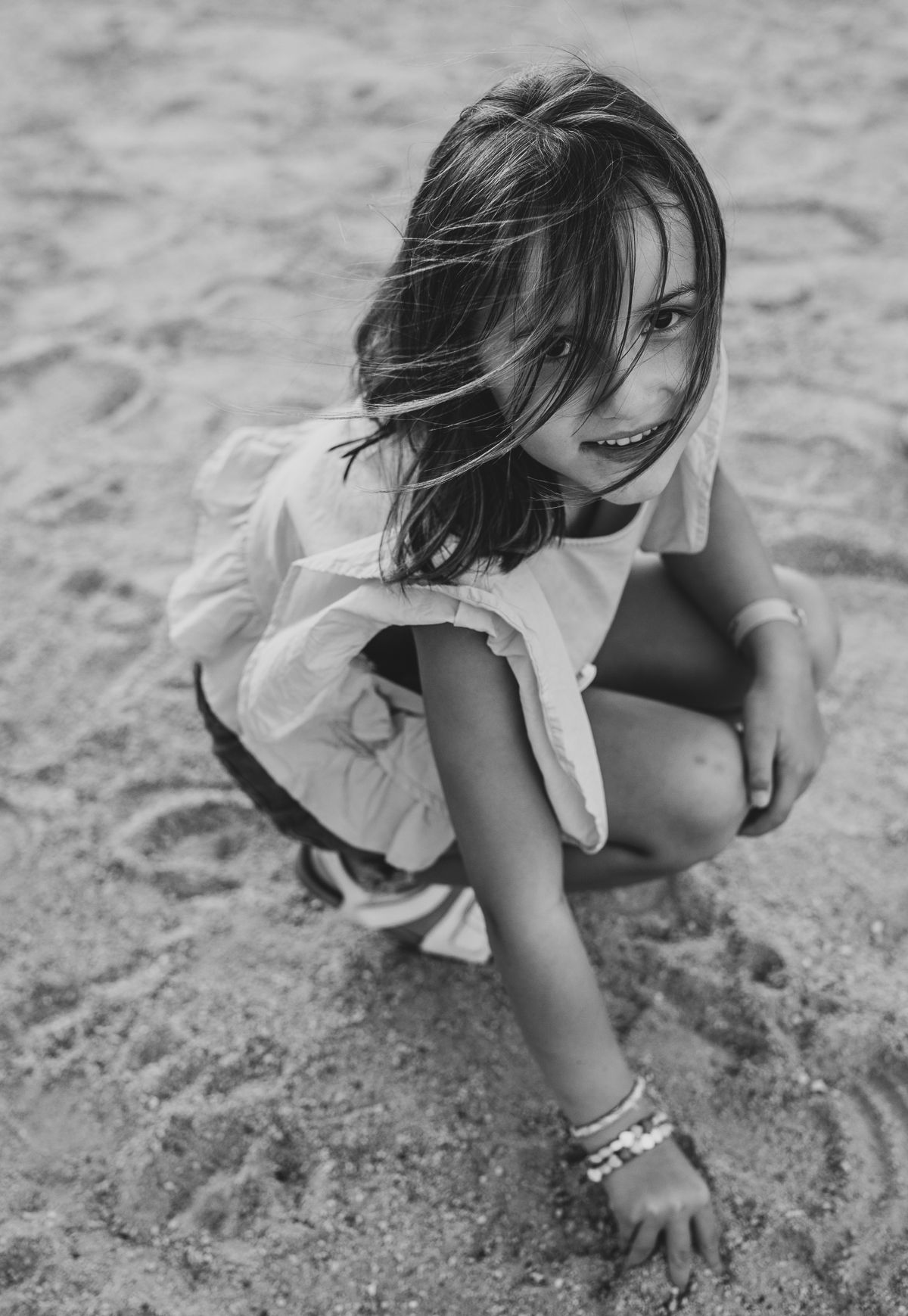A girl on the beach during a family photoshoot outdoors
