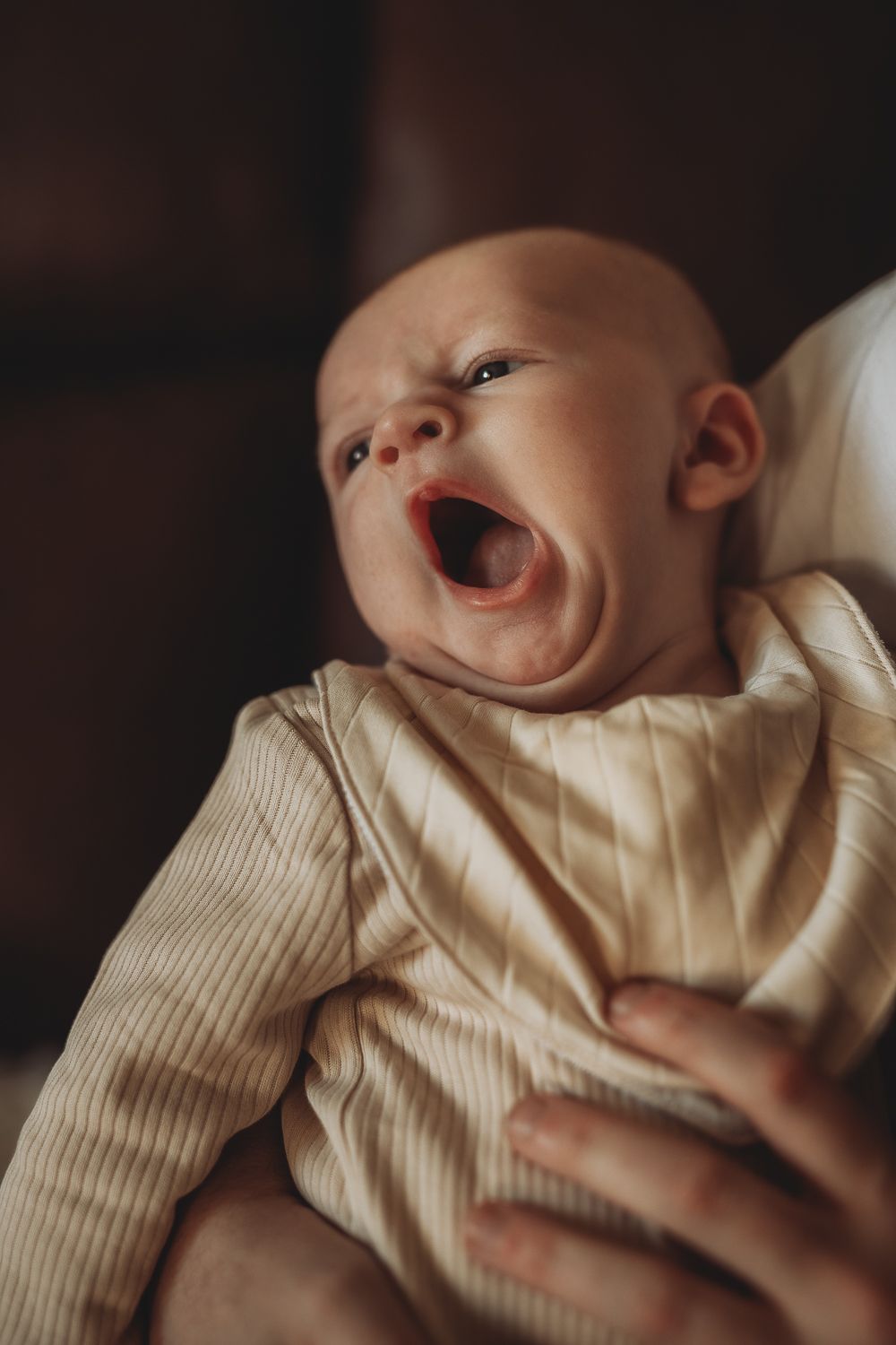 A portrait of a baby captured during a home photoshoot, documentary-style family photography capturing everyday life
