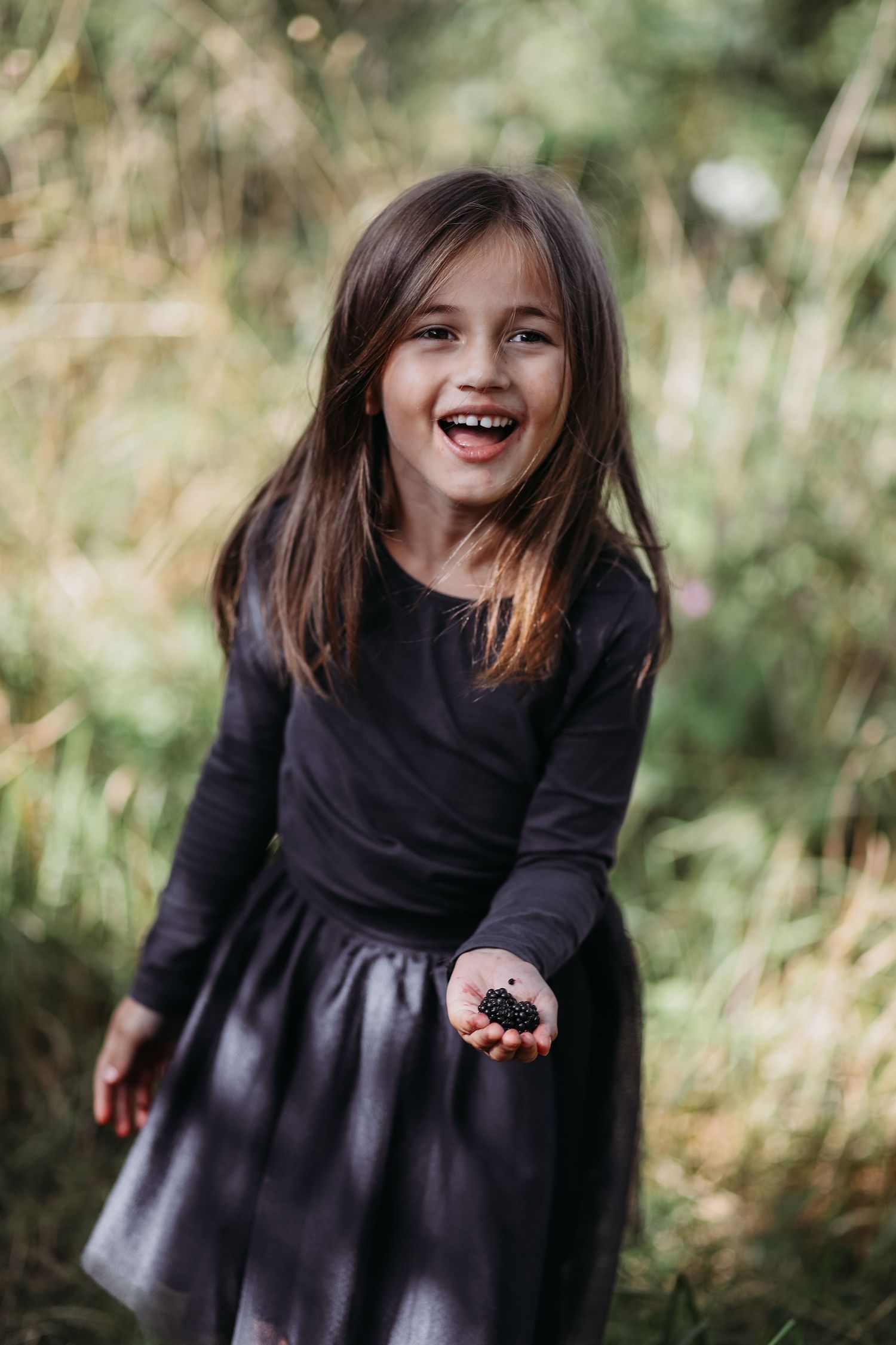 A child laughing during natural family photography session outdoors in Angus
