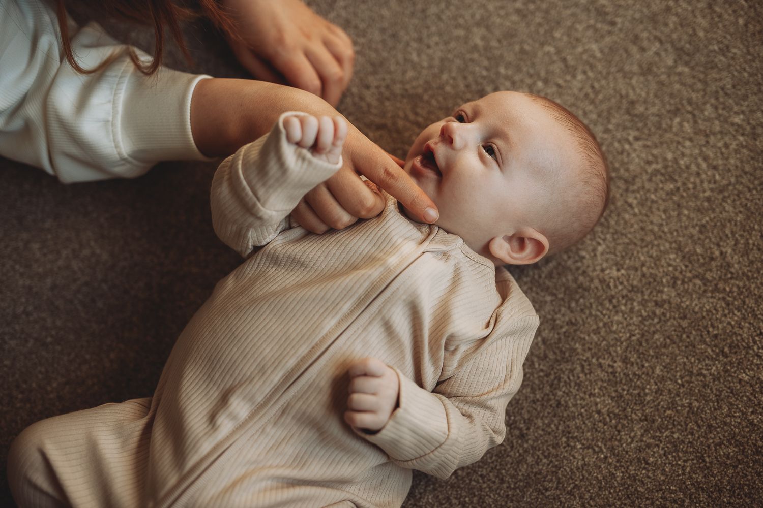 Candid moment between mother and baby during home photoshoot in Angus