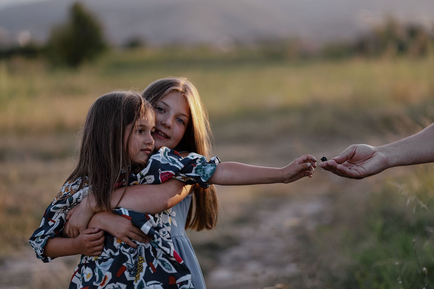 Children laughing during natural family photography session outdoors