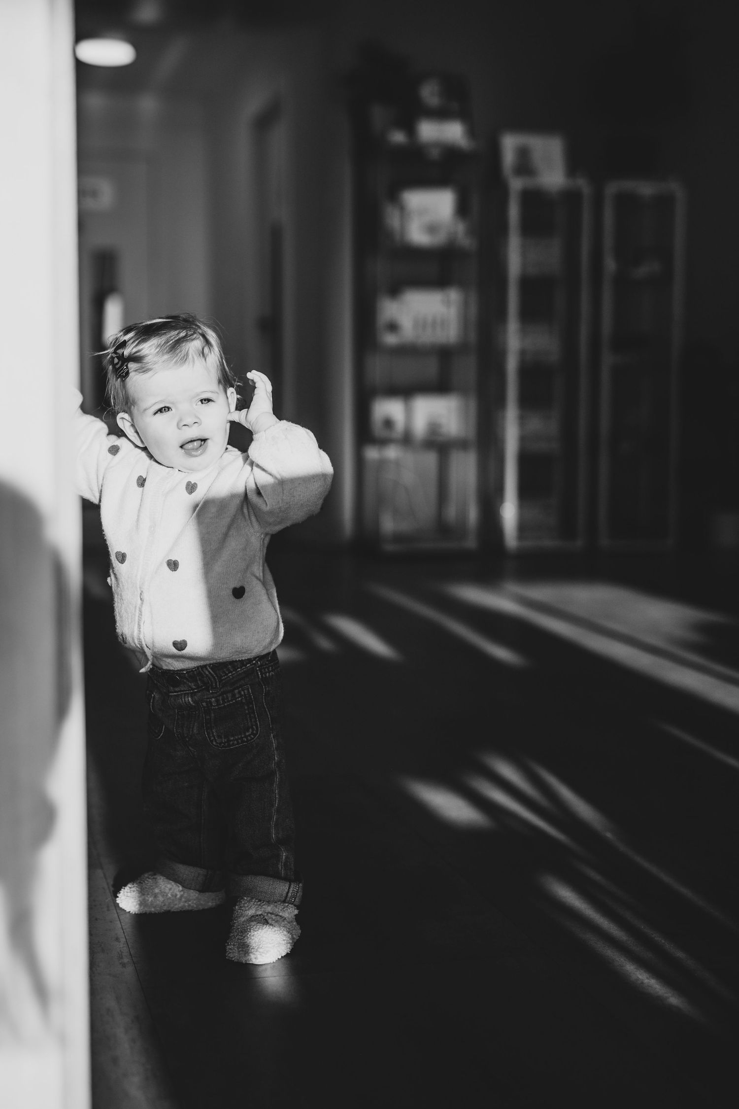A toddler during a family photoshoot indoors