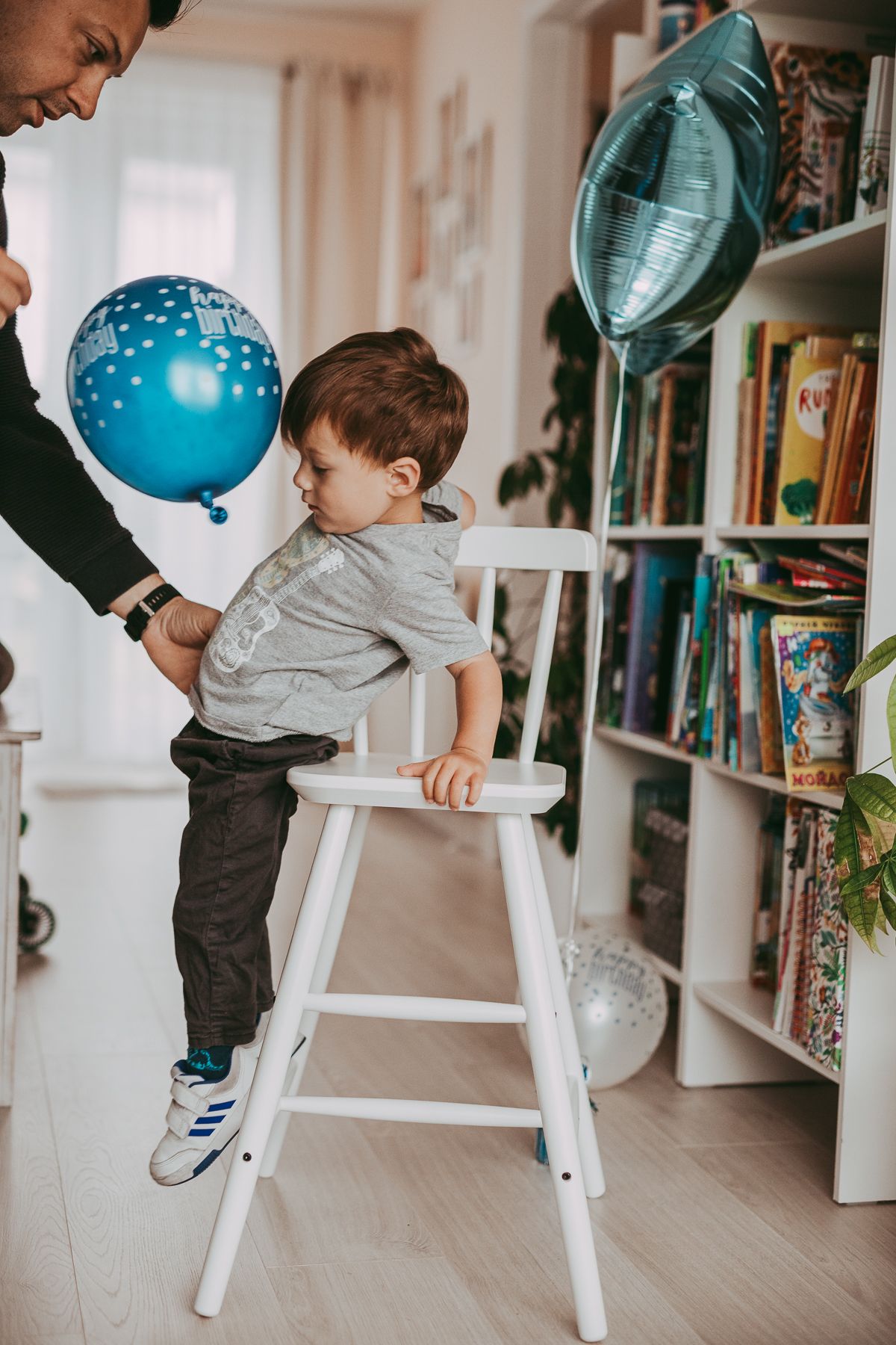 Father and son captured during a  relaxed birthday family photoshoot indoors