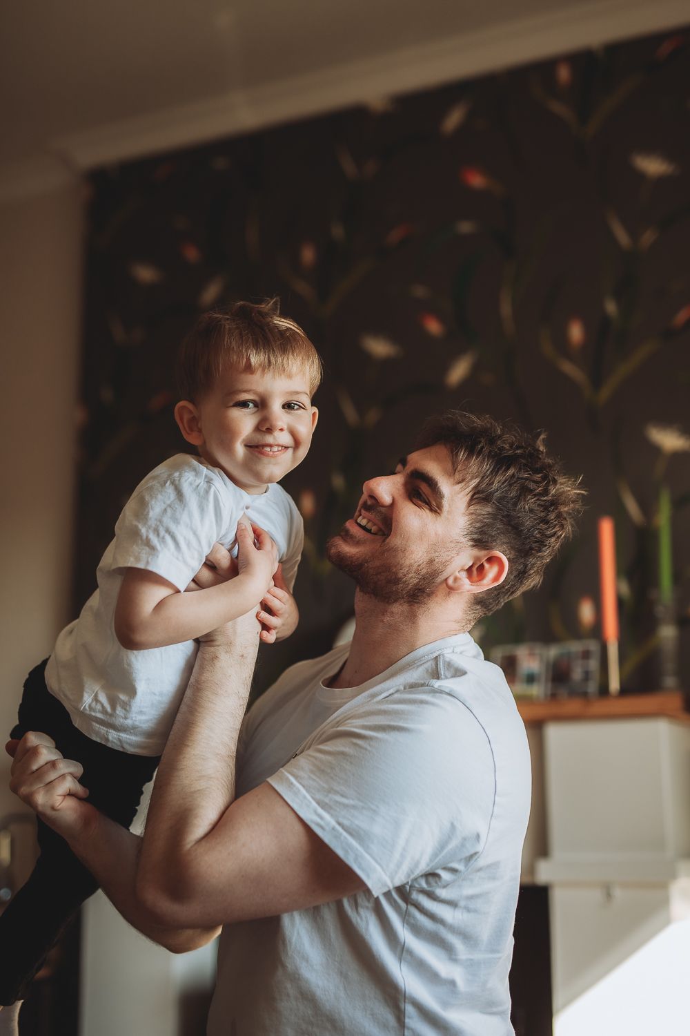 Candid moment between father and son during home photoshoot