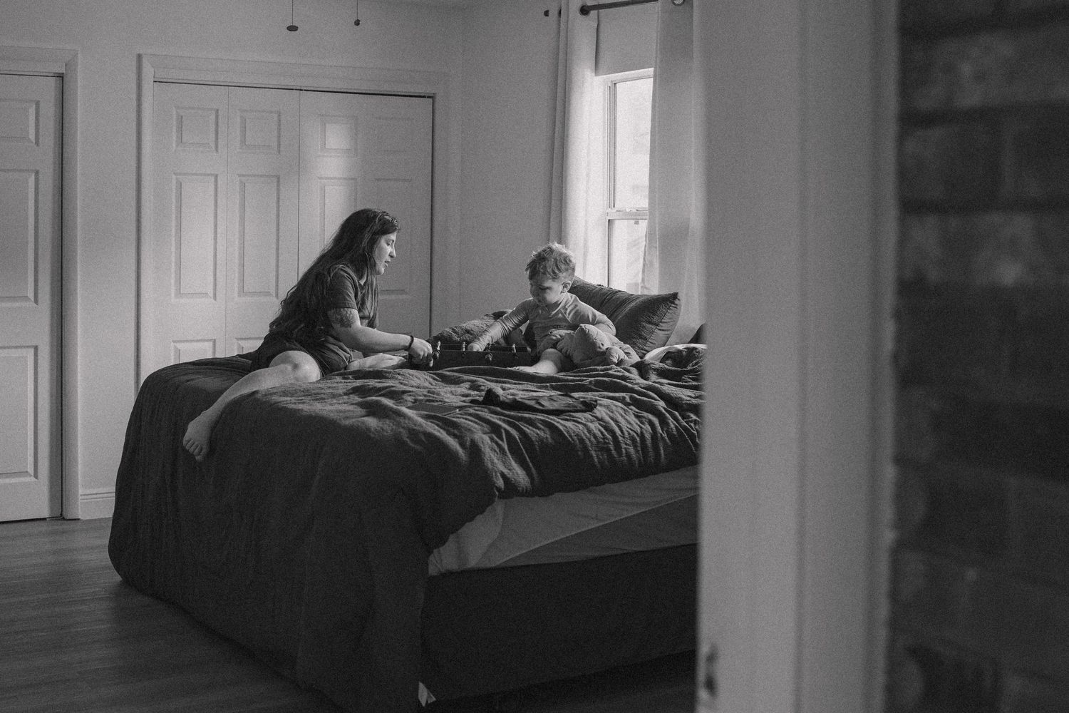 Interior view of a bedroom with natural light streaming through windows.