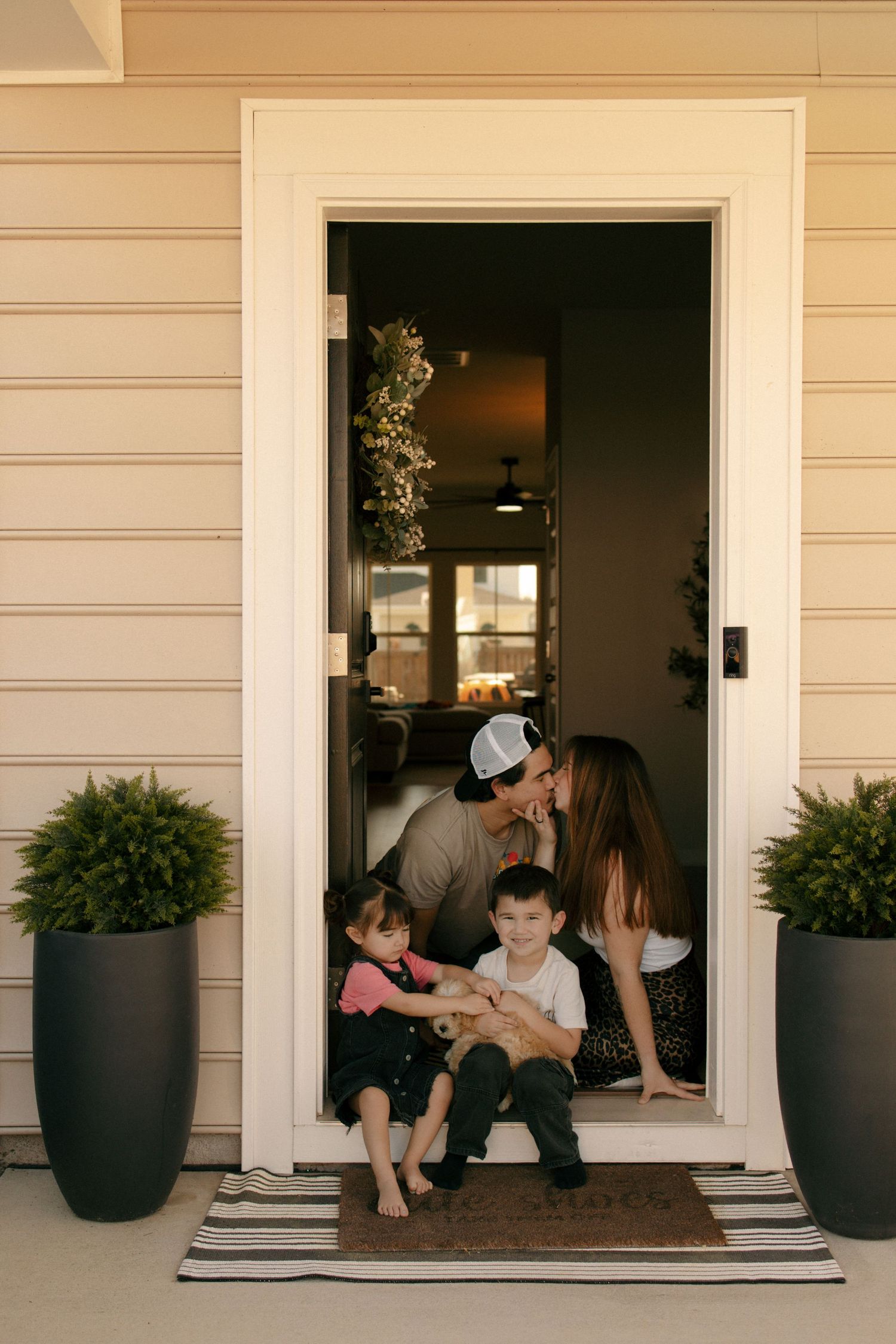 timeless candid photo. Family lifestyle income shoot. siblings hugging. Family dog. Family of four.