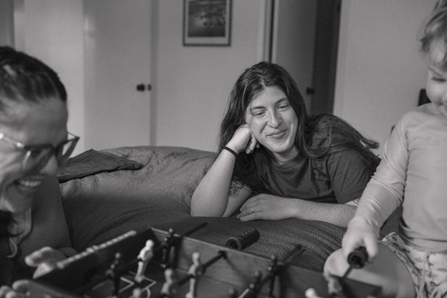 Black and white photo of people relaxing in an indoor setting.