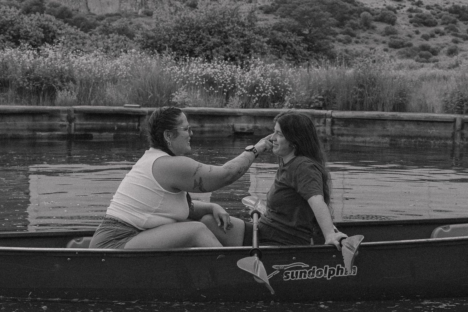 People enjoying a peaceful day canoeing on a calm lake or river.