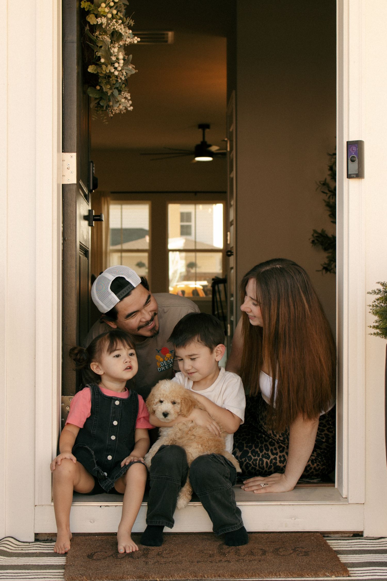 timeless candid photo. Family lifestyle income shoot. siblings hugging. Family dog.