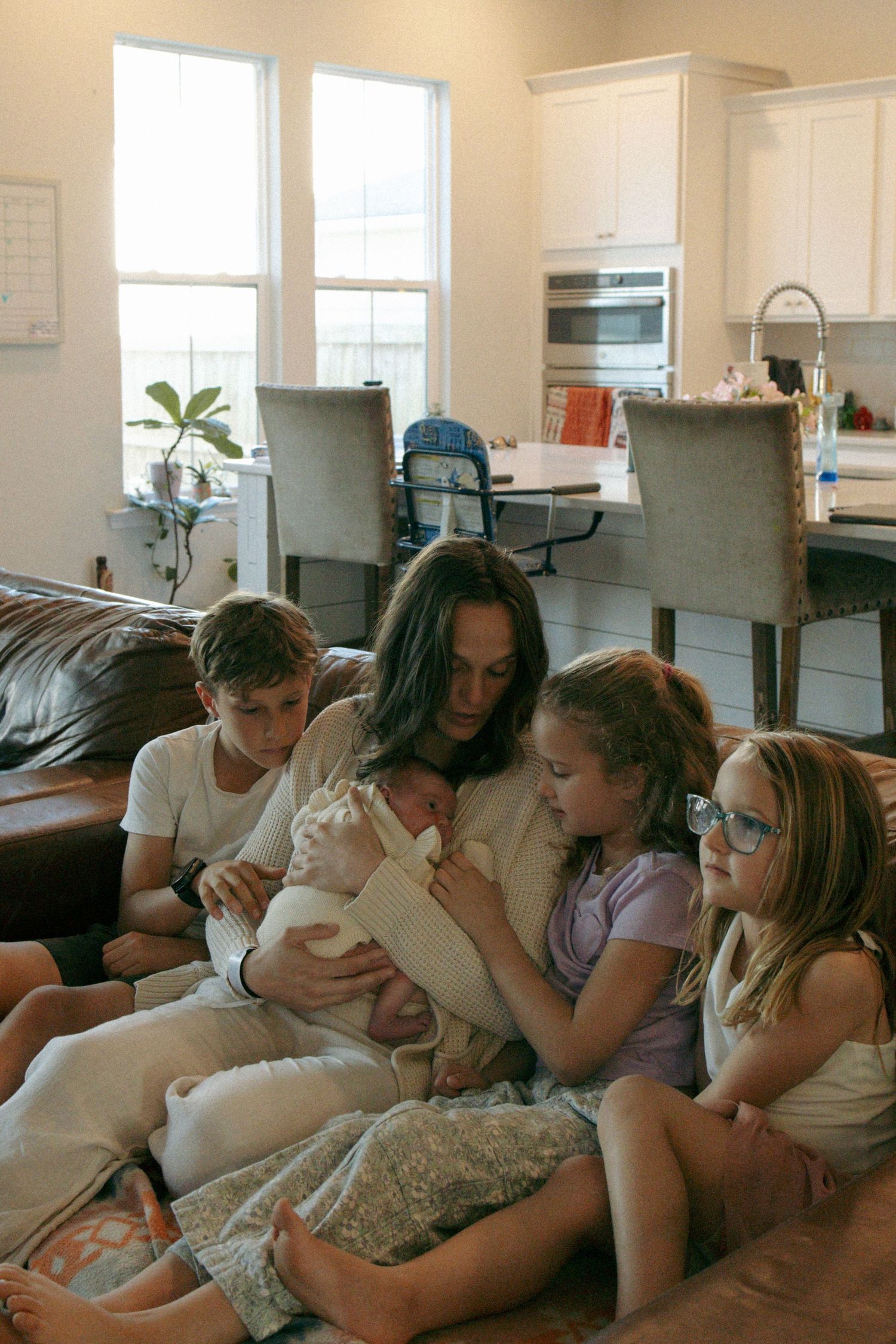 A series of five connected photos showing a group relaxing together on a couch, progressively getting closer to each other.