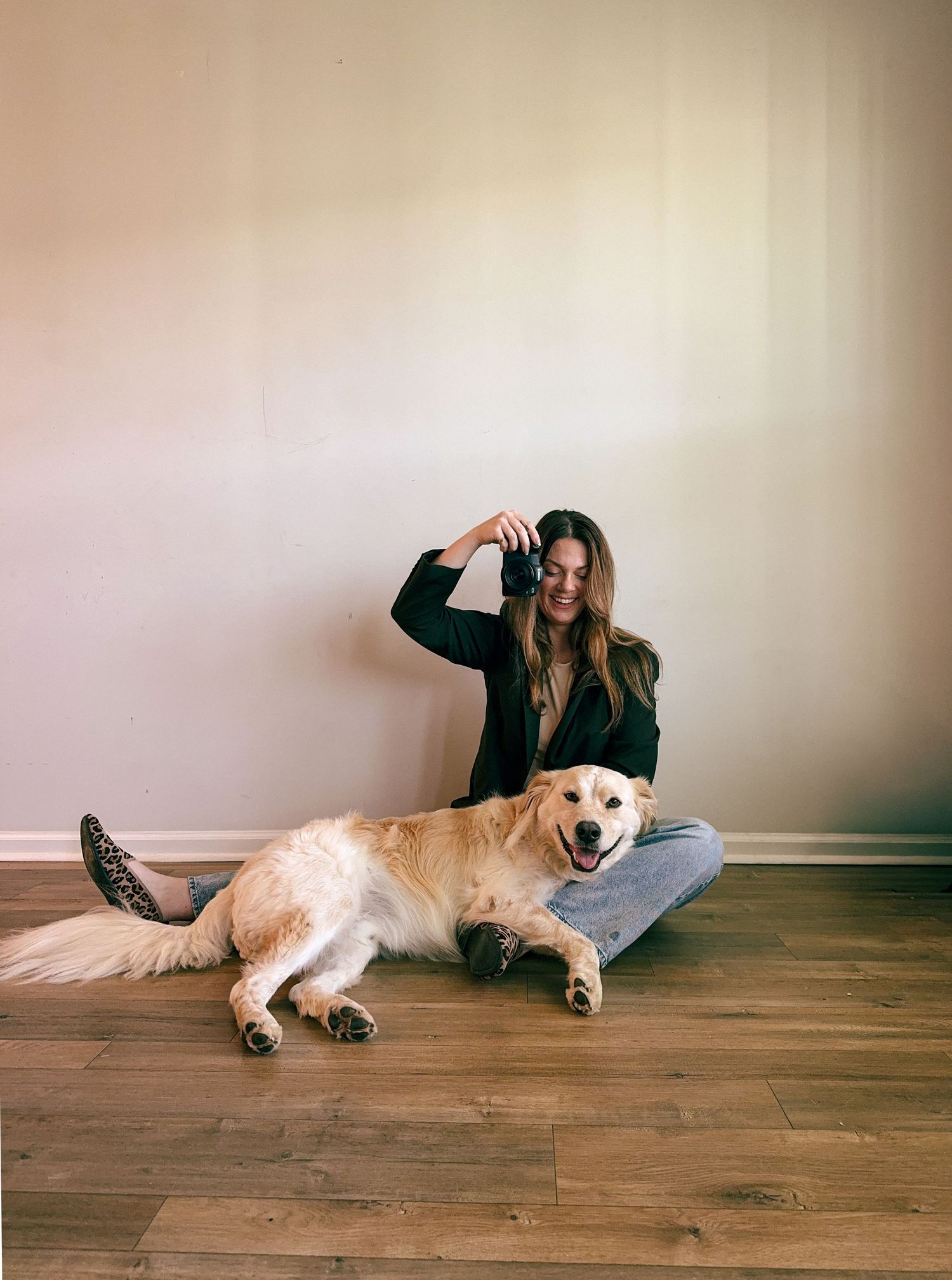 A series of four photos showing a person relaxing on a hardwood floor with a golden retriever dog.