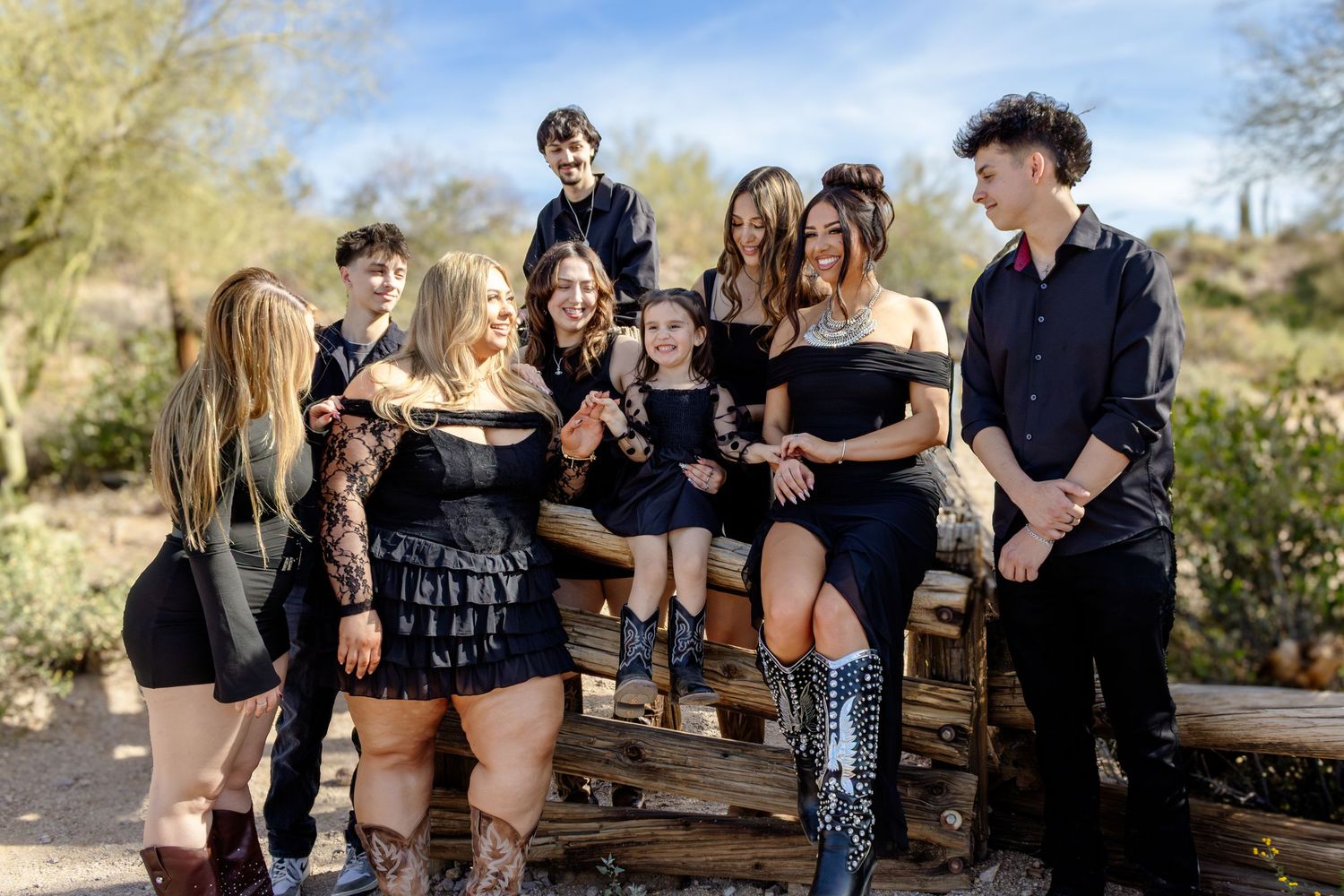 candid family sibling photo. Older children in black in lost dutchman state park, Arizona. Cowboy themed family photos