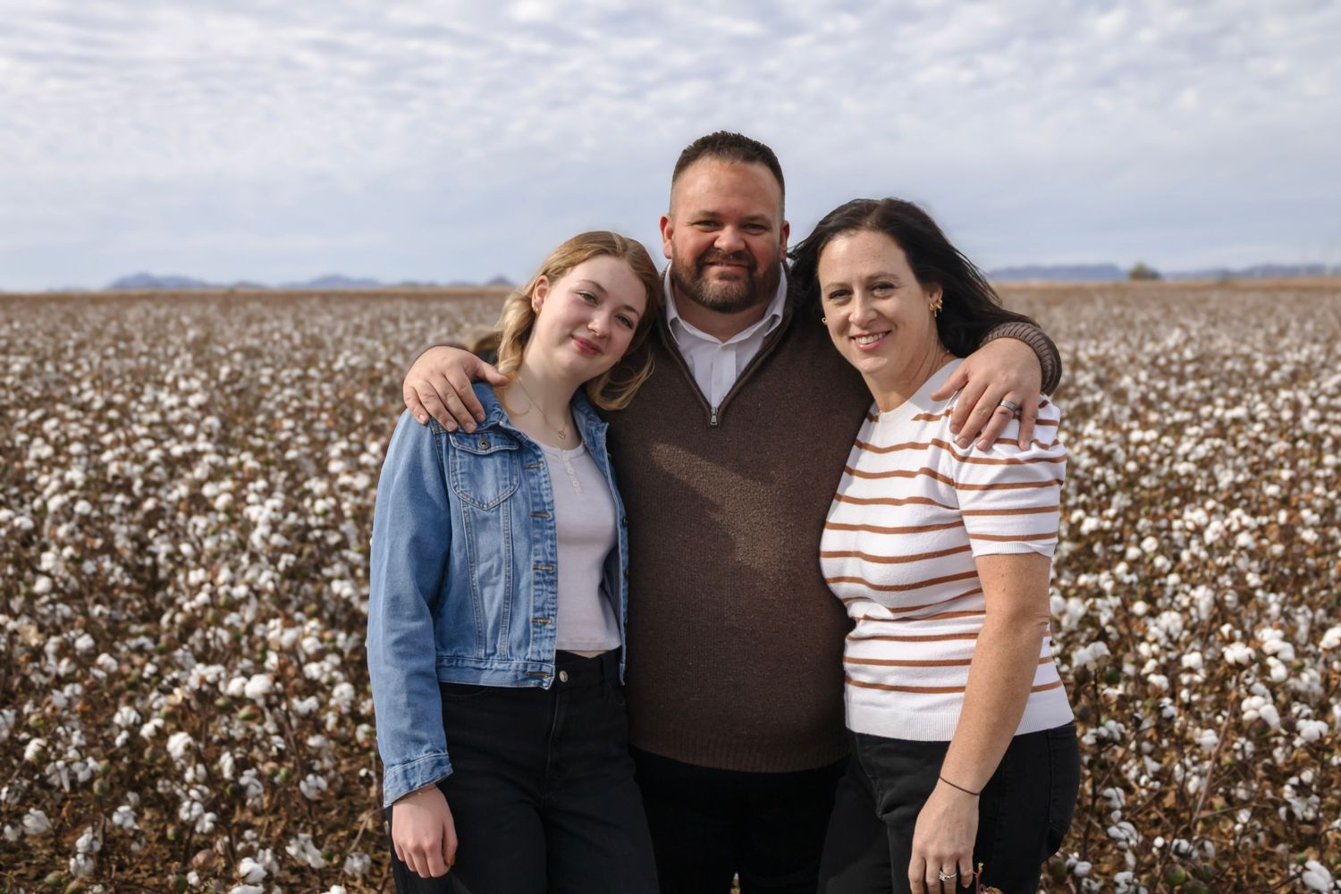 Natural, airy family photo in a cottonfield in florence arizona. Family of 3 photo