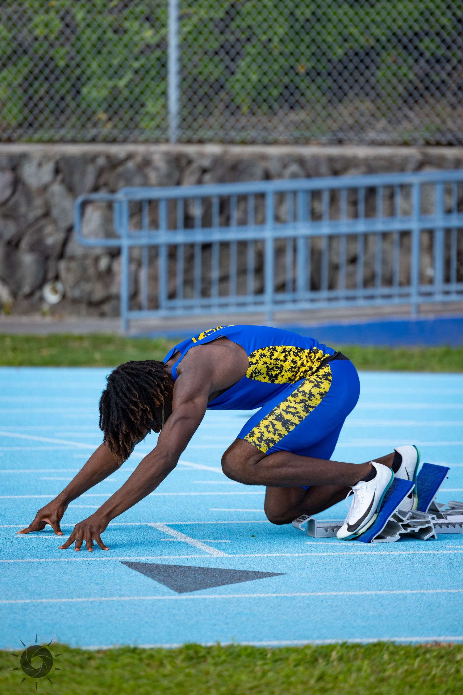 A sequence showing an athlete falling forward onto a blue track in a dramatic finish at the finish line.