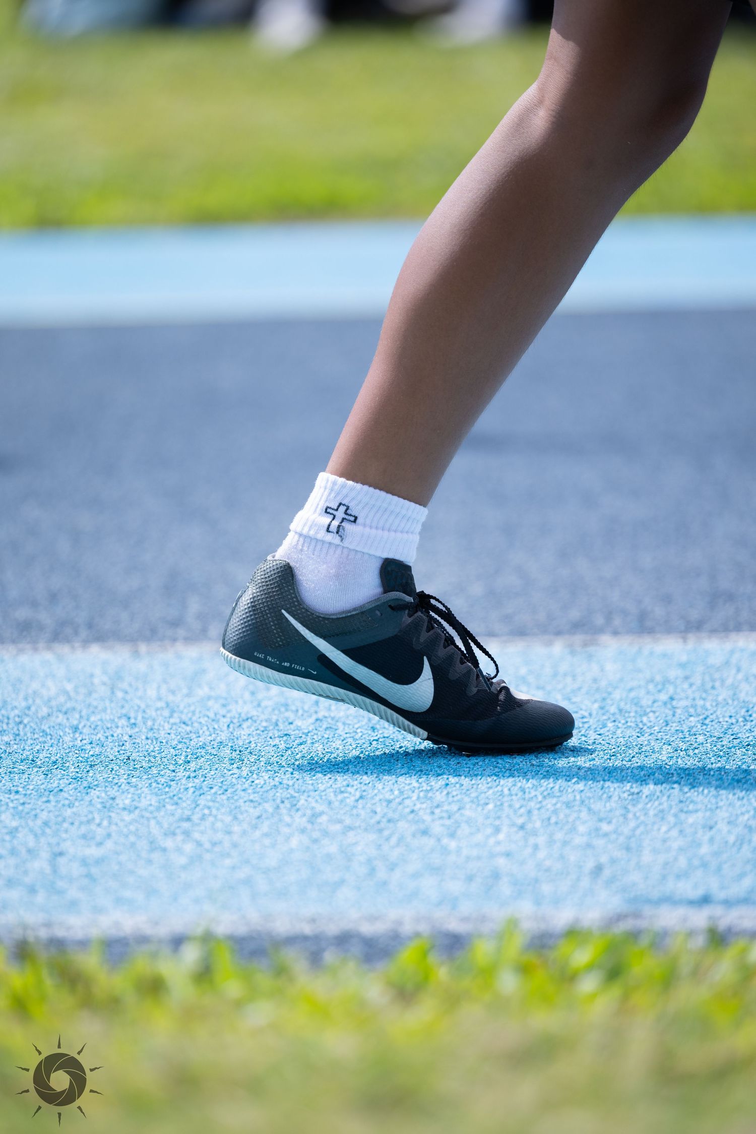 Close-up sequence of feet walking on blue track surface showing progression of steps in athletic shoes.